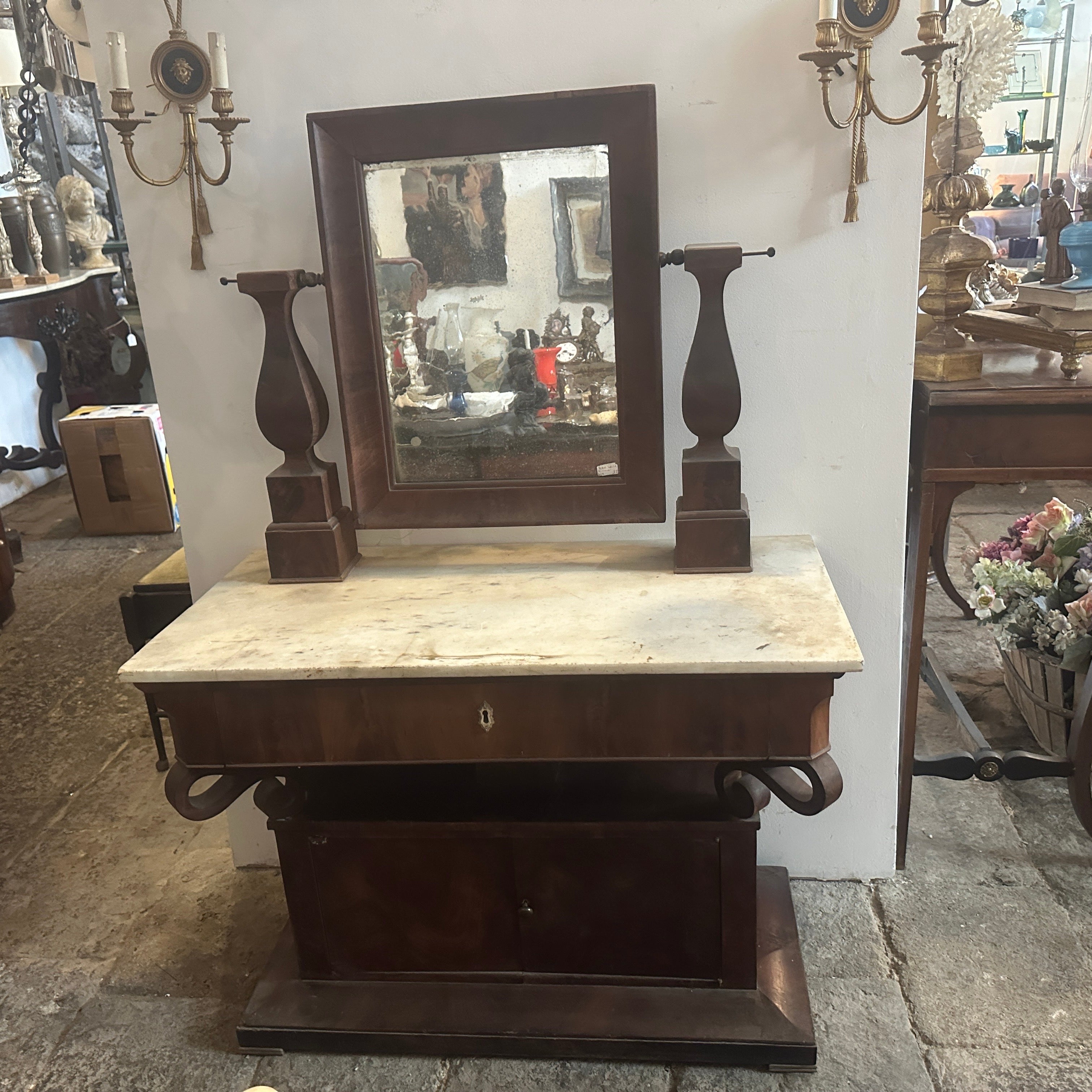 This Sicilian vanity table is an exquisite piece of furniture representative of the design trends and craftsmanship of that era. The primary structural material is fir wood, chosen for its strength and workability. The exterior is veneered in