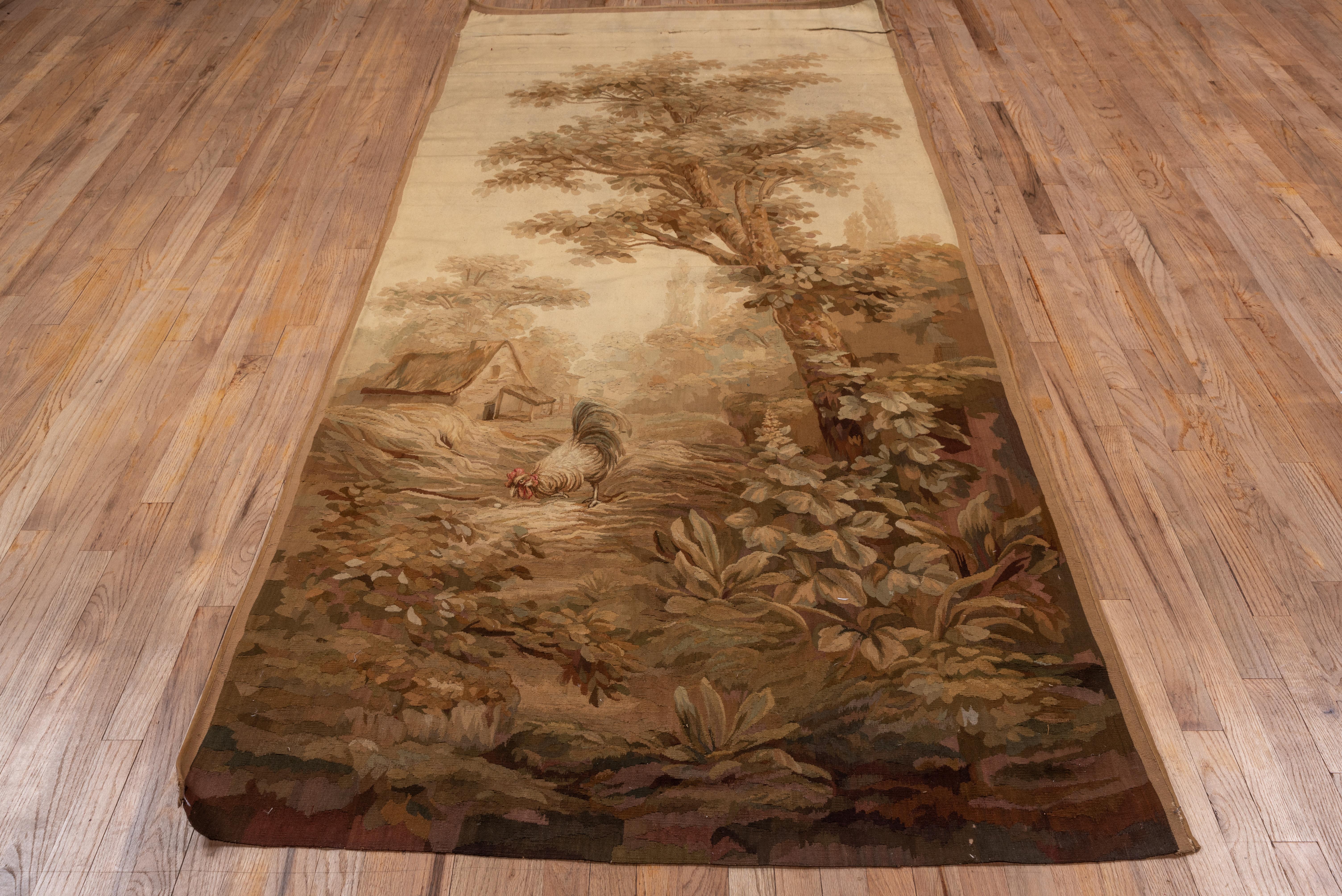 In an 18th century Verdure style, but 19th century in origin Beauvais tapestry work. A tall tree shades a farmhouse yard with foreground wild plants, a pecking chicken and a rustic dwelling behind. Hazy summer aerial perspective. No borders.