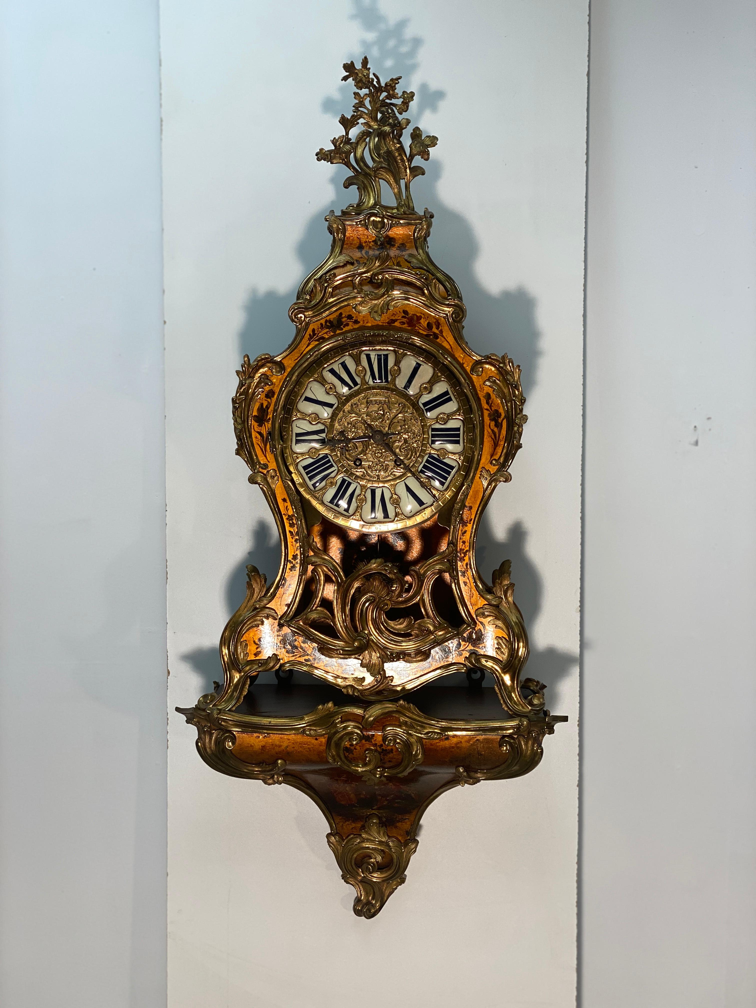 Very ornate large 19th century French mantle clock. Three sections. The bracket mounts to the wall with two eyelets on the rear. The main clock and the bonnet rest upon this bracket. The clock could also be displayed by itself without the bracket.