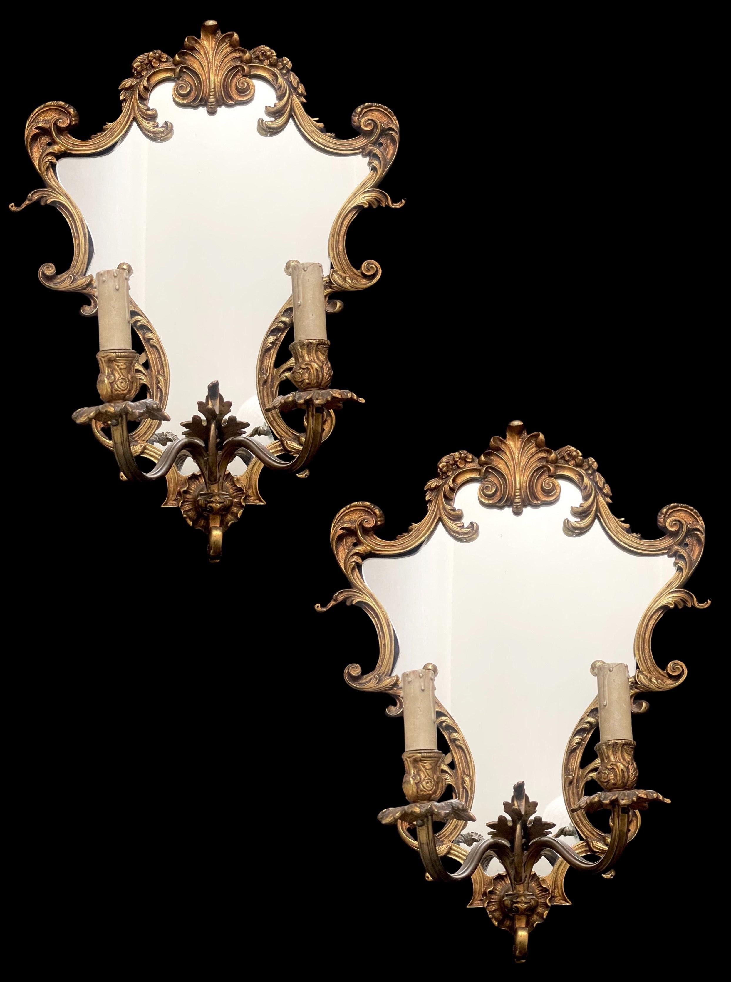 Admire the intricate beauty of the scrolling and curves that delicately frame the mirrored surface, showcasing the patina brass in all its vintage glory. Each curve and line tells a story of craftsmanship and artistry that transcends the