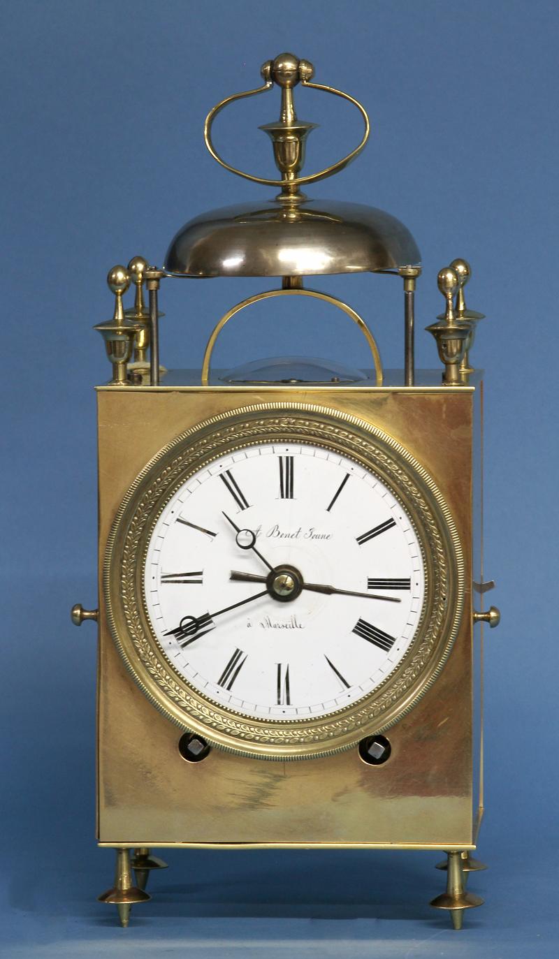 Maker: 
A Benet Jeune
Vincenti & Cie.
Fumey

Case: 
The polished bronze rectangular case has solid hinged doors to the sides and back, shaped feet and finials, an engine turned bezel and has the bell and stirrup handle supported by an arched