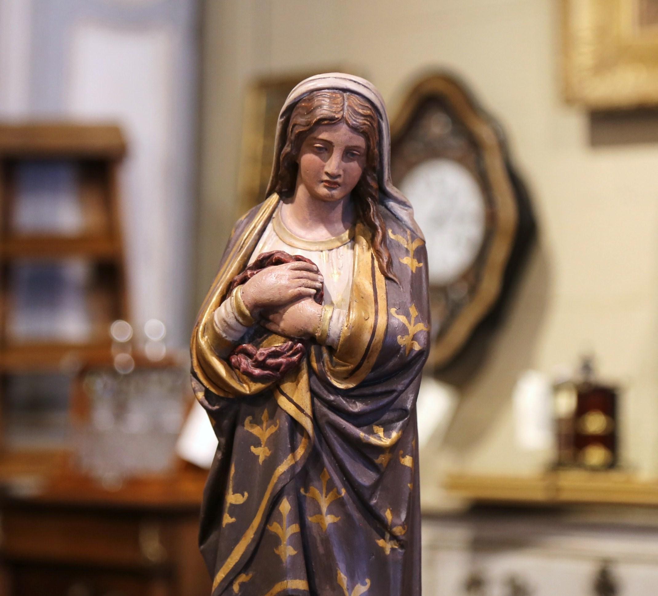 This beautiful, antique sculpture of the Virgin Mary was created in Provence, France, circa 1870. Embellished with gold leaf and polychrome finish, including floral motifs, the Classic figure is beautifully ornate and has wonderful details