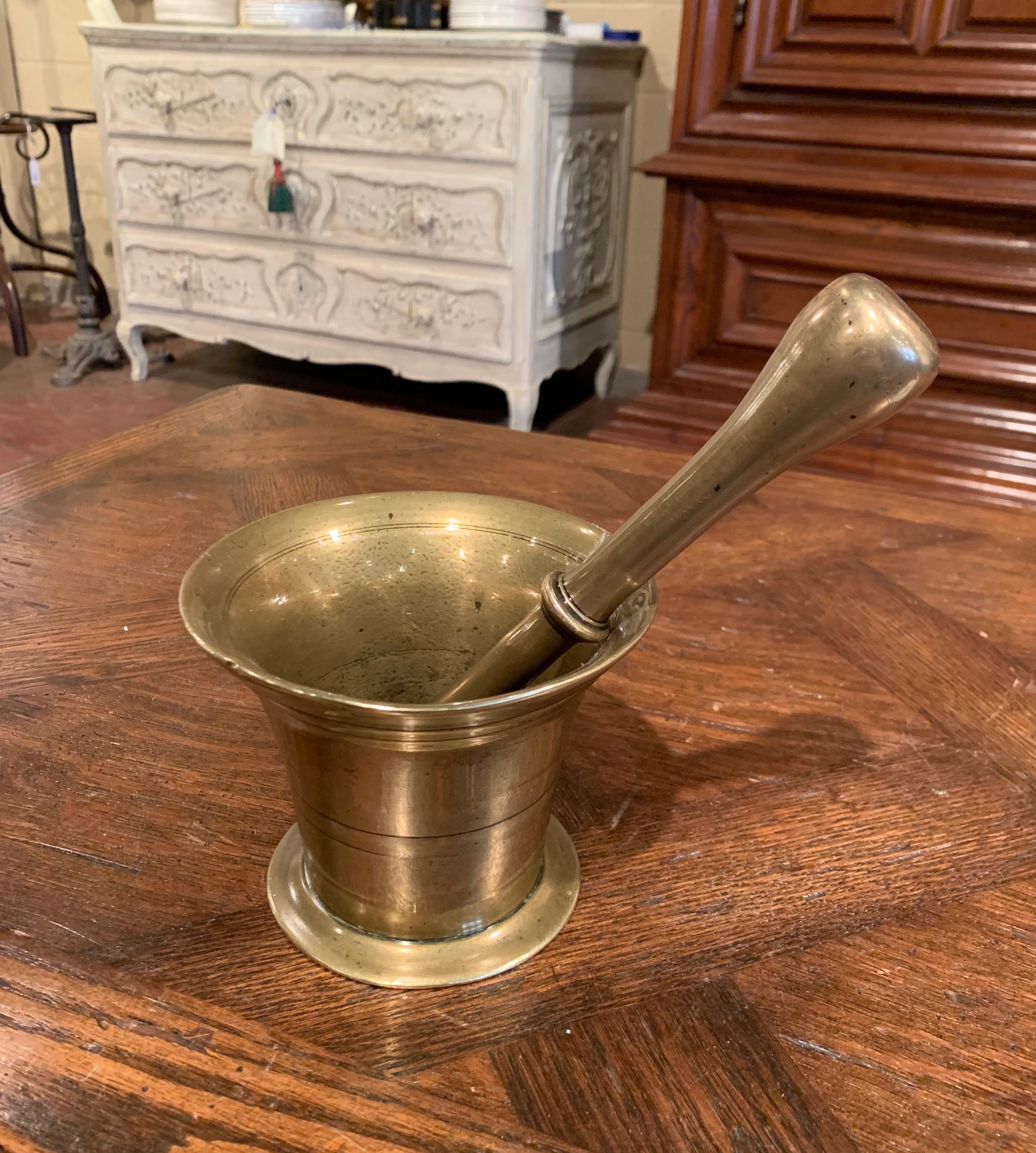 Grind spices in your kitchen with this beautifully carved, antique mortar; crafted in France, circa 1860, and made of bronze, the decorative bowl is round in shape with a wide mouth at the top. The kitchen essential is in excellent condition with