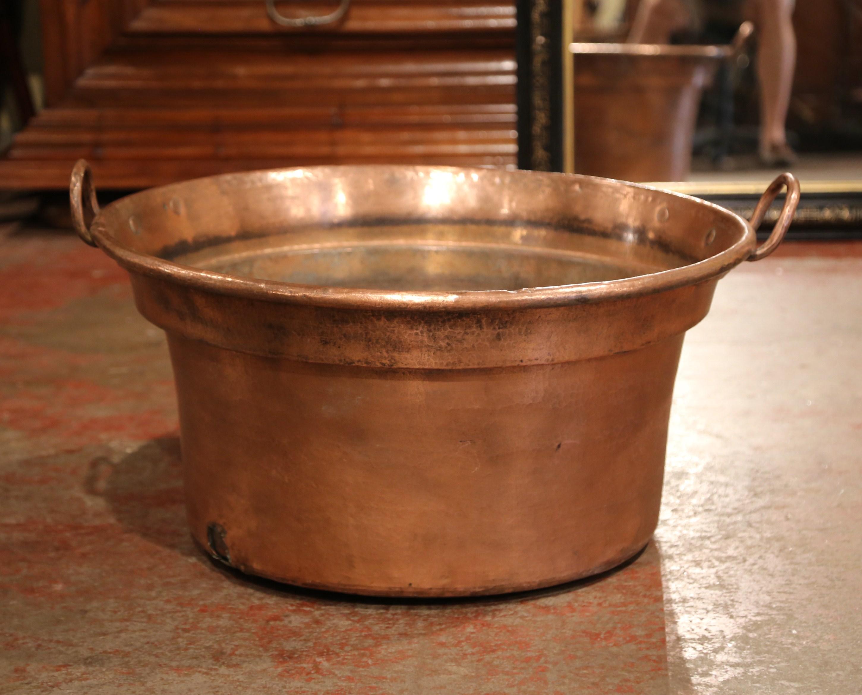 Keep your drinks cold in this important, antique, copper marmalade bowl! Crafted in Normandy, France, circa 1860, the large decorative“Bassine a Confiture”, or jelly bowl, is round in shape; it features two brass handles on the sides, which are