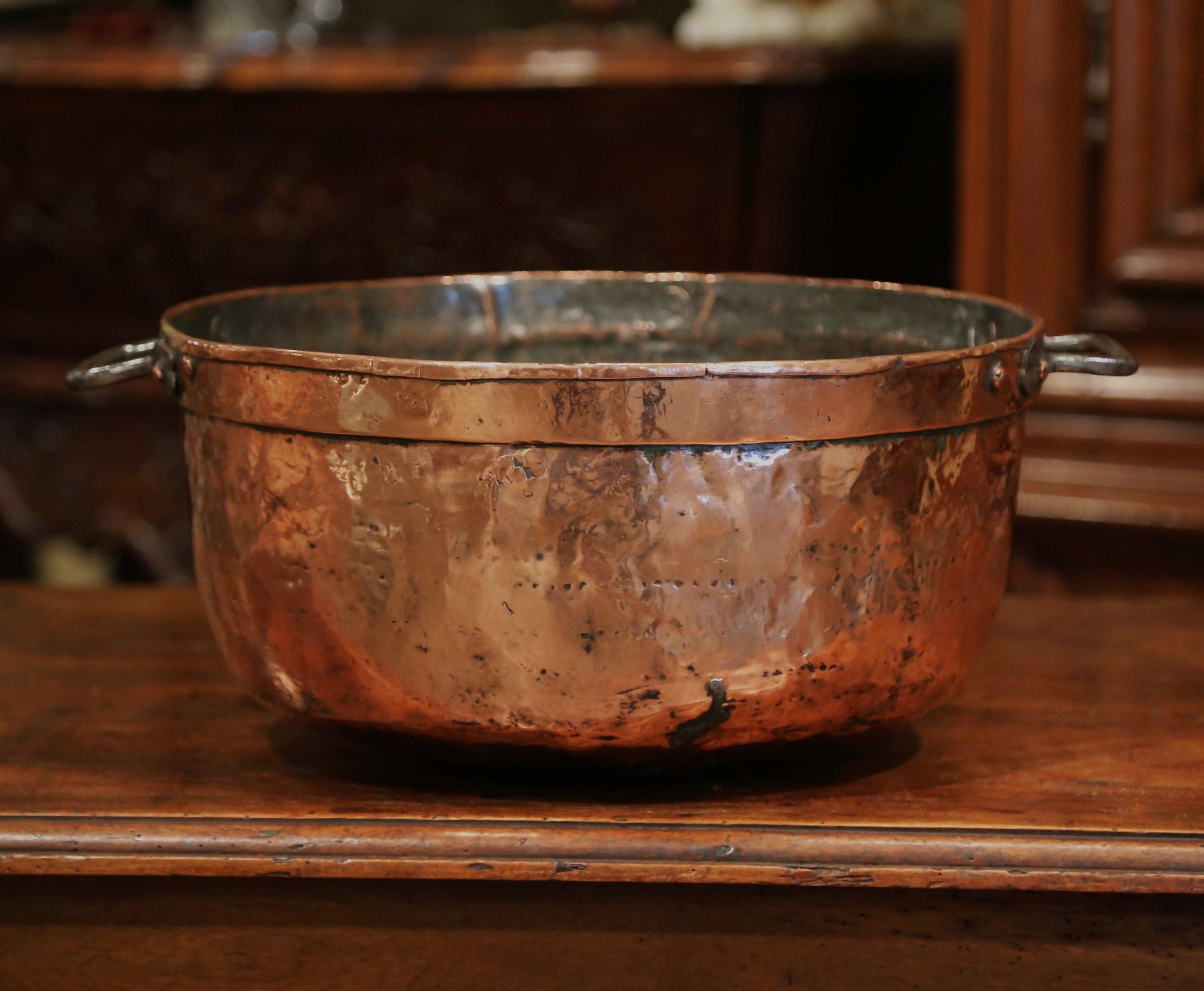 This large, antique, copper marmalade bowl was crafted in Normandy, France, circa 1860. The decorative round “Bassine a Confiture” (jelly bowl), features two forged iron handles on the sides attached with rivets. The simple, traditional kitchen