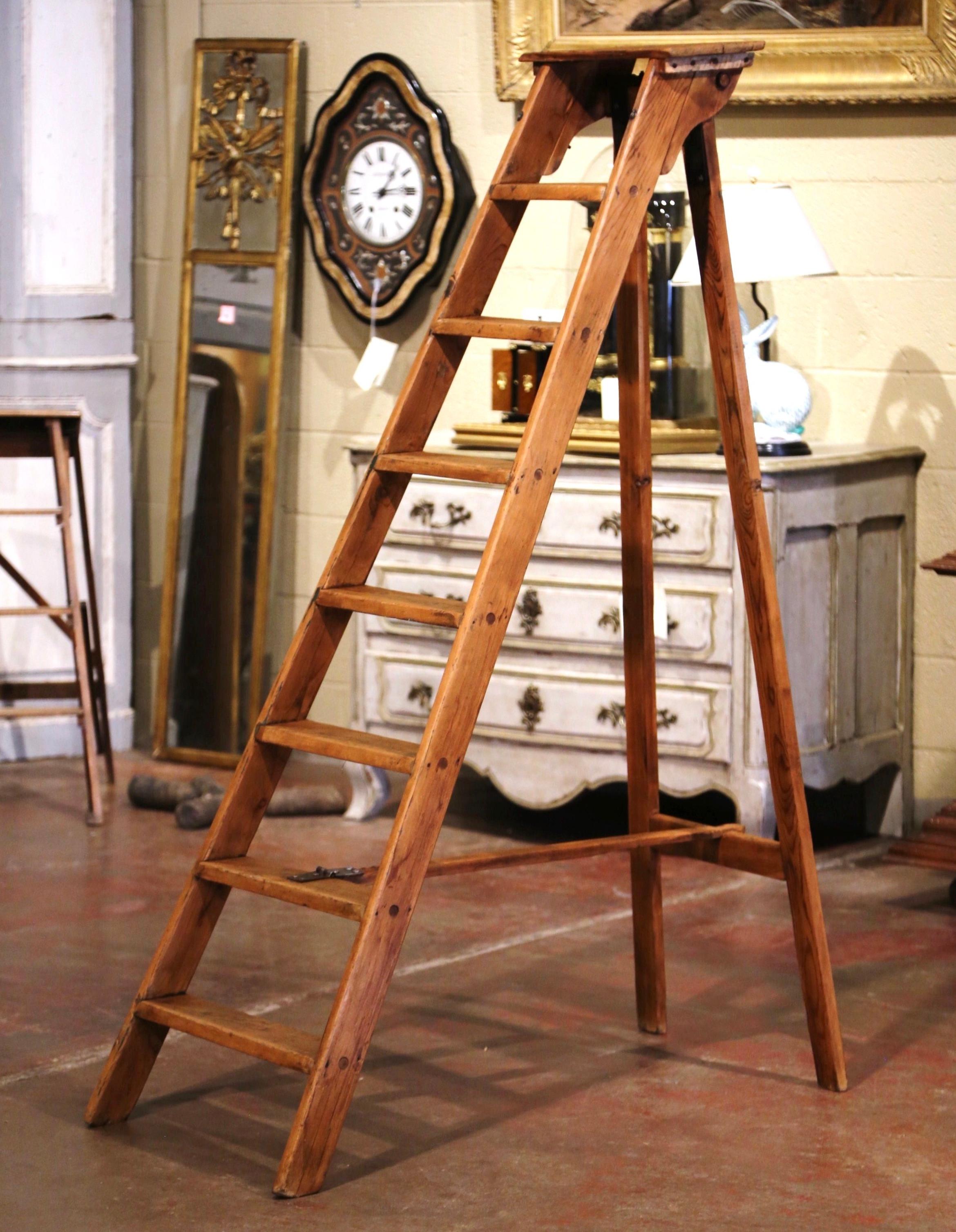This elegant six and a half foot antique ladder was created in Northern France, circa 1850. Made of solid pine, the sturdy step ladder features eight steps including a wider and deeper step at the top. Practical and useful, the rustic ladder can be