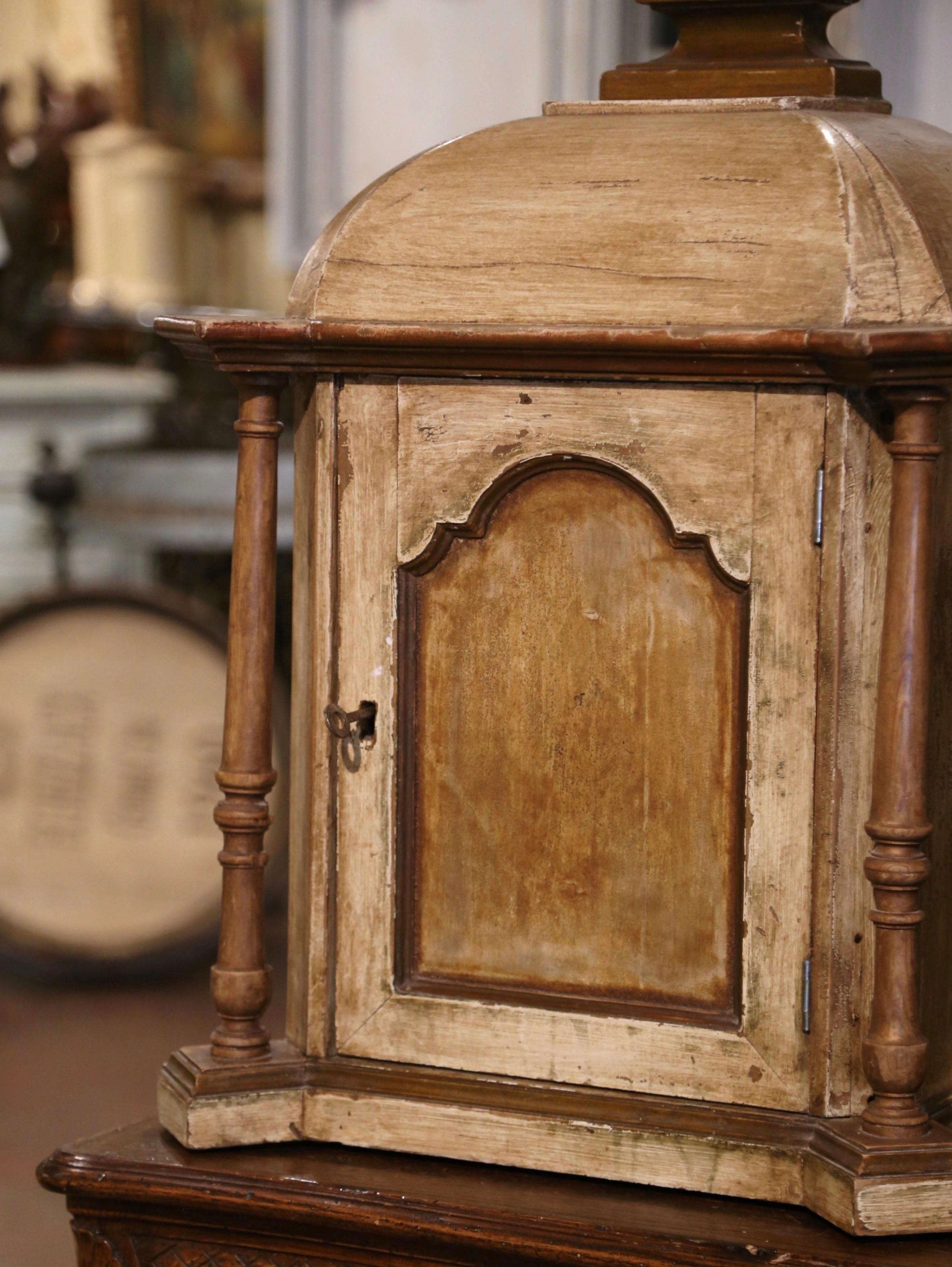 This elegant and petite antique vitrine was crafted in France, circa 1860. Originally used as a tabernacle in a church or chapel, the hanging cabinet features a dome top over a single door decorated with turned columns on each side. The door