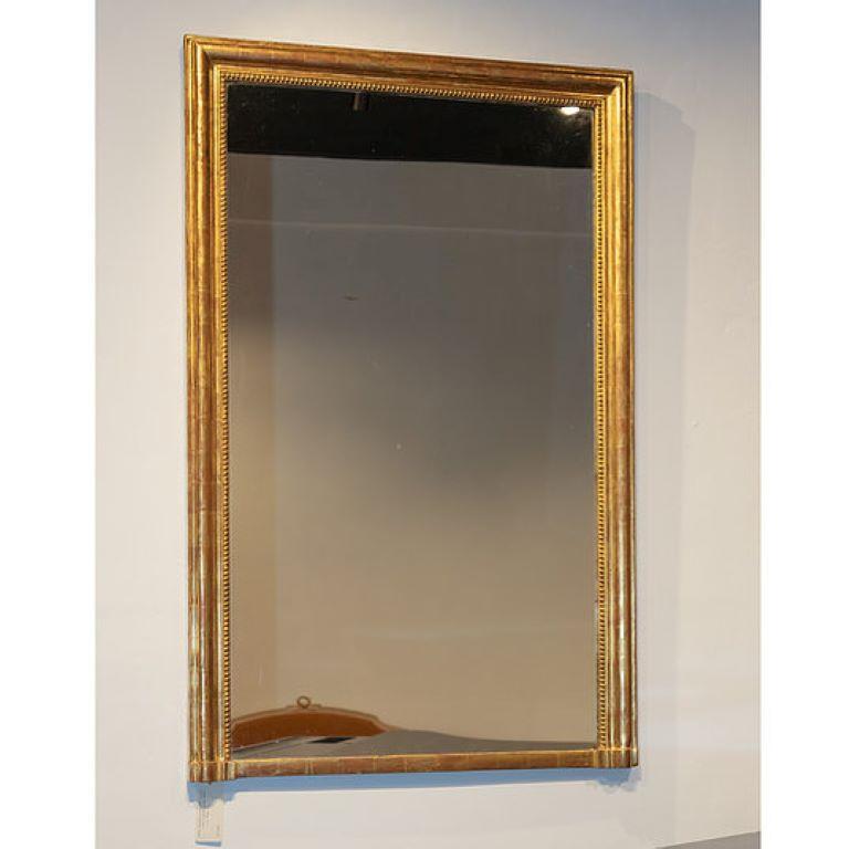 A Mid 19th Century, French, gilt framed over mantle mirror with a moulded edge and beading framing the mirror plate.

Over mantle mirrors were designed to be placed above a fireplace but in nowadays an overmine mirror can sit comfortably over a