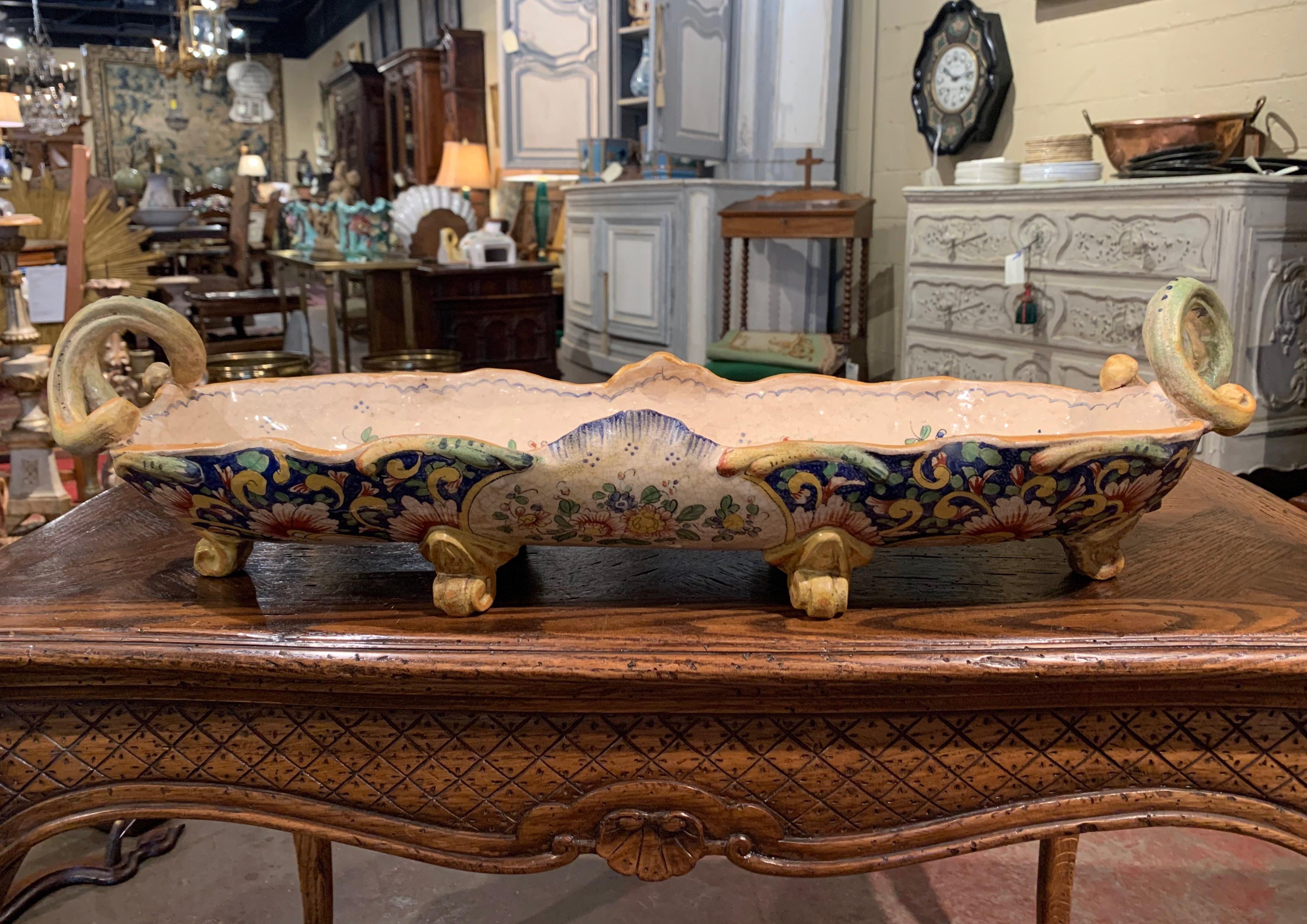 Decorate a dining room table or a mantel with this large antique jardinière; crafted in Normandy, circa 1860, the oblong planter stands on scrolled feet and features scrolled handles on the sides over a scalloped rim. The long ceramic dish is hand