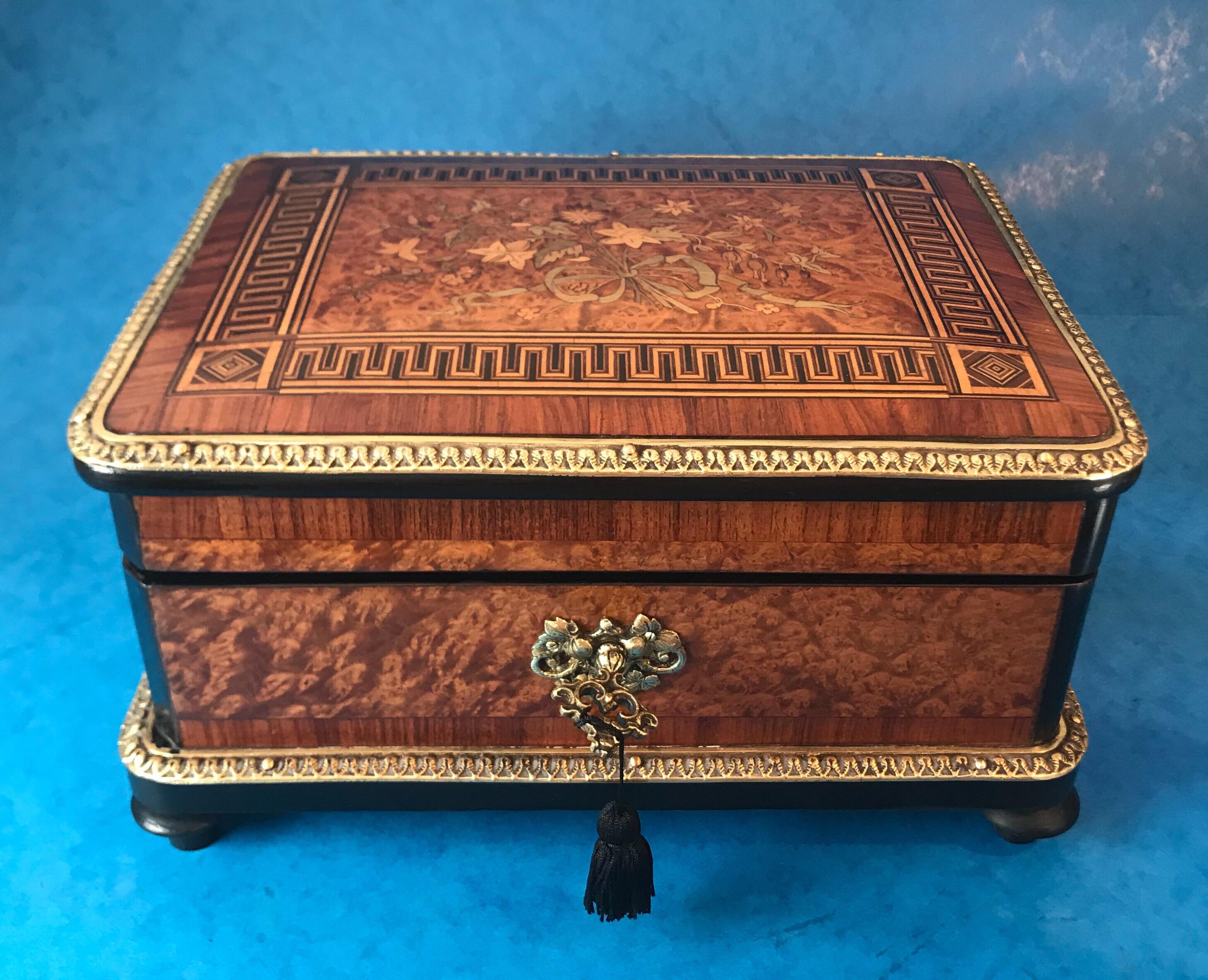 Mid-19th century French Kingwood cross banded box. The box is a truly elaborate and a magnificent piece. It has a grecian key design with a floral marquetry panel to the centre of the box, it has burr cedar sides which are cross banded in Kingwood