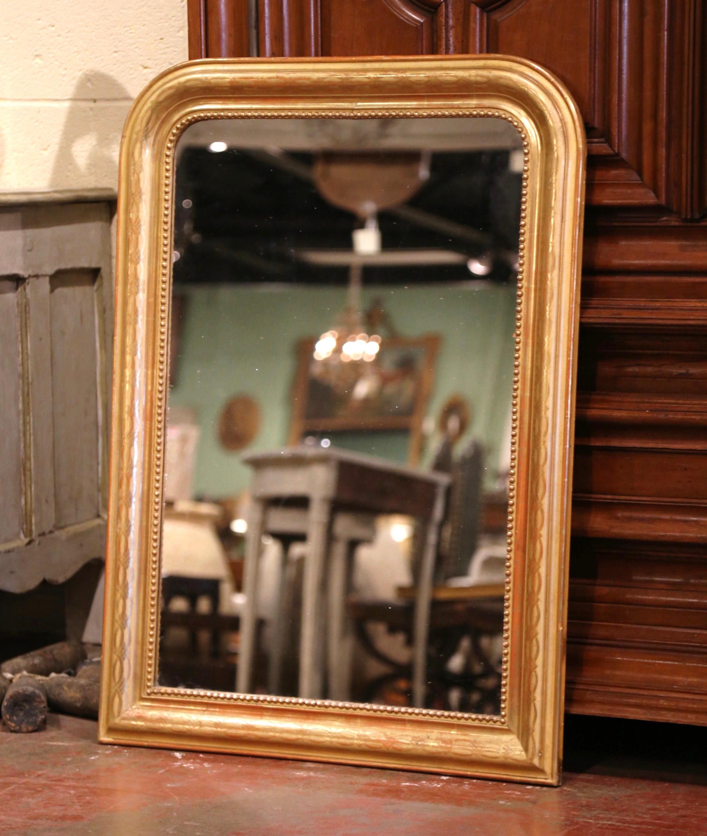 Decorate an entry or a powder room with this elegant antique mirror with original gold leaf finish. Crafted in the Burgundy region of France, circa 1860, the large, rectangular Louis Philippe mirror has traditional lines with rounded corners; the