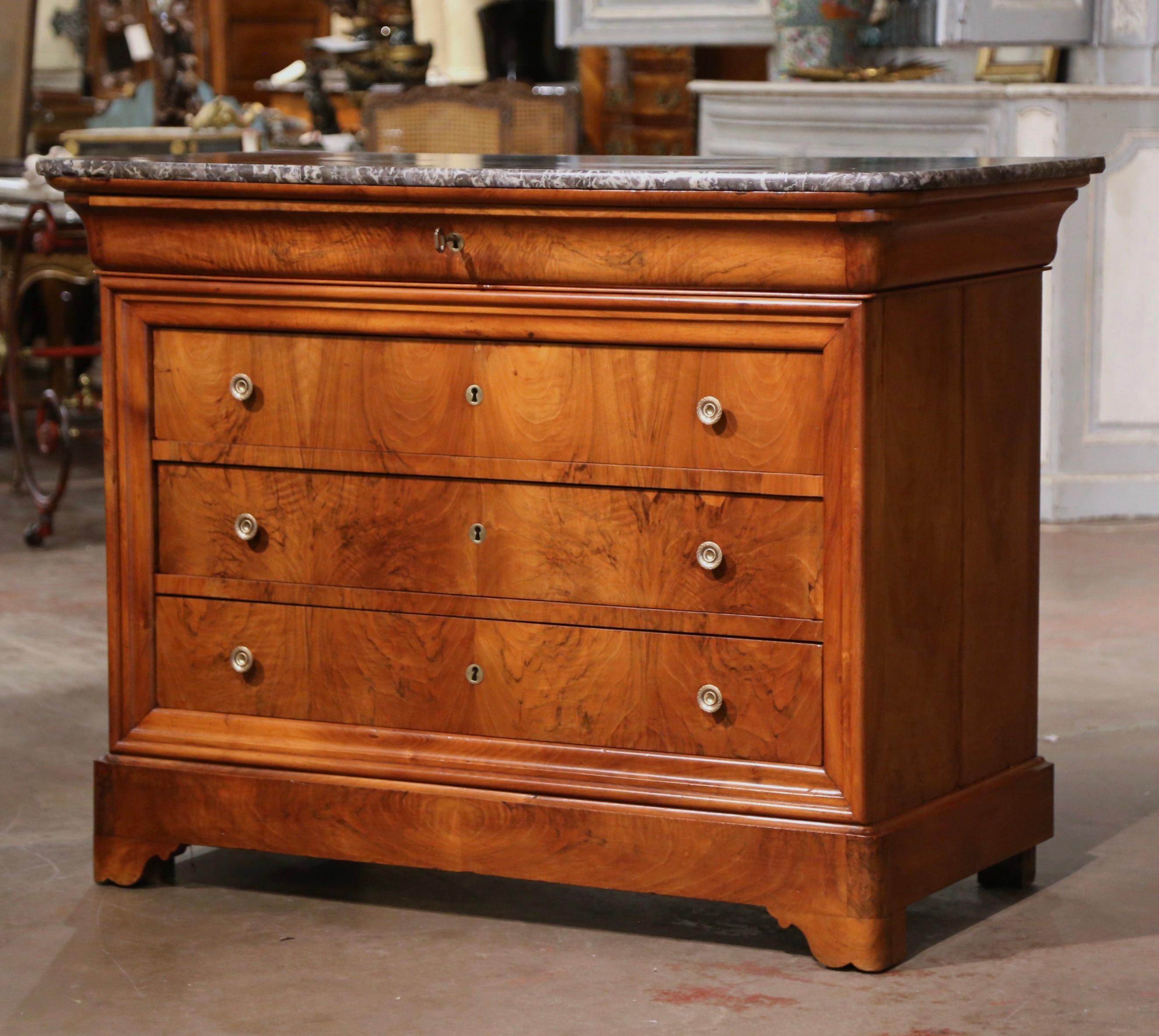 This elegant, antique chest of drawers was crafted in France, circa 1870. Built of walnut, the traditional commode with simple lines stands on front bracket feet over a thick and raised base plinth; the cabinet features four long drawers across the