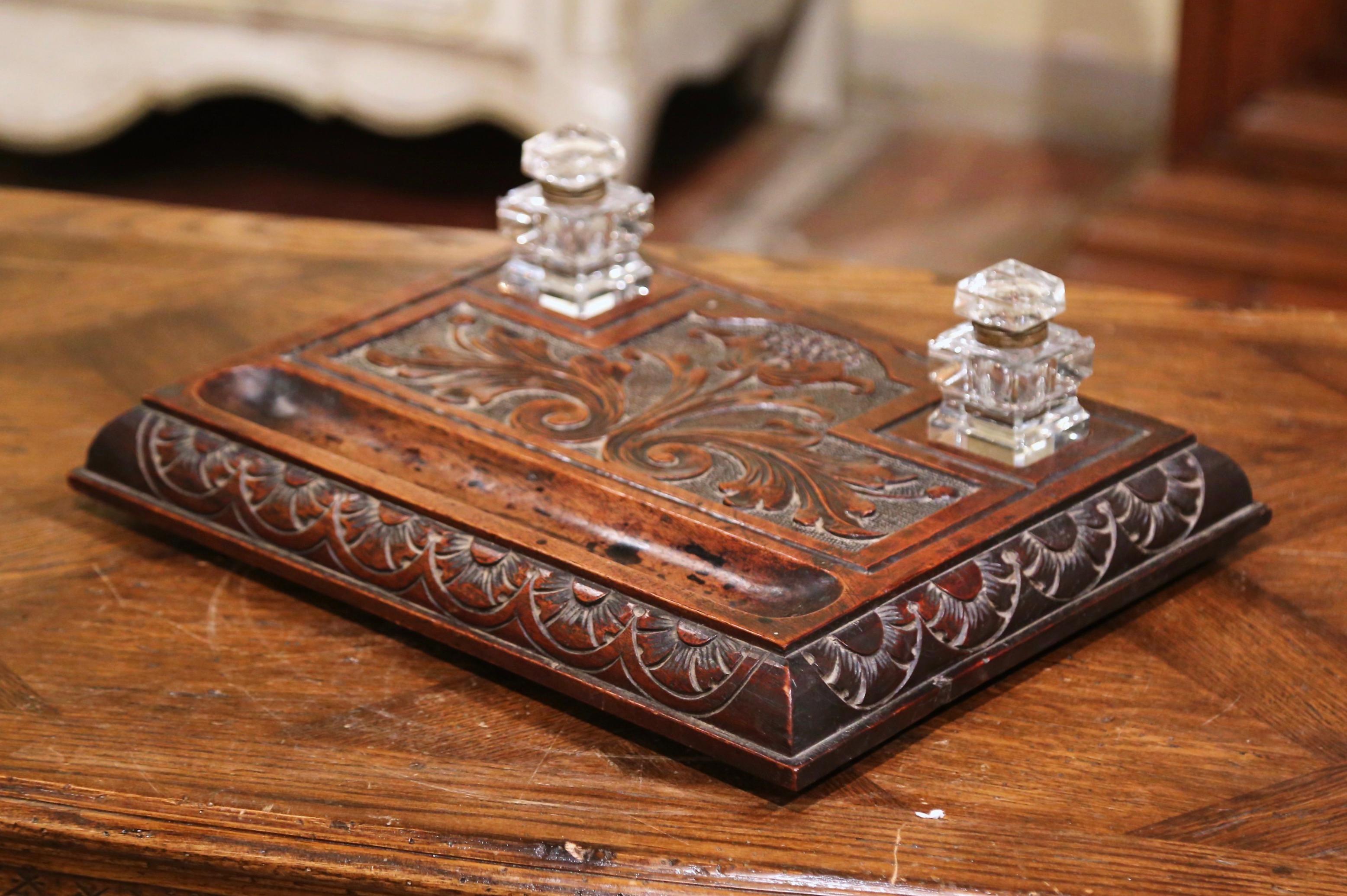 Decorate a man's office desk with this elegant antique inkwell. Created in France circa 1870, the inkwell is rectangular in shape and features hand carved floral motifs on the surface with pens holder, and further embellished with acanthus leaf