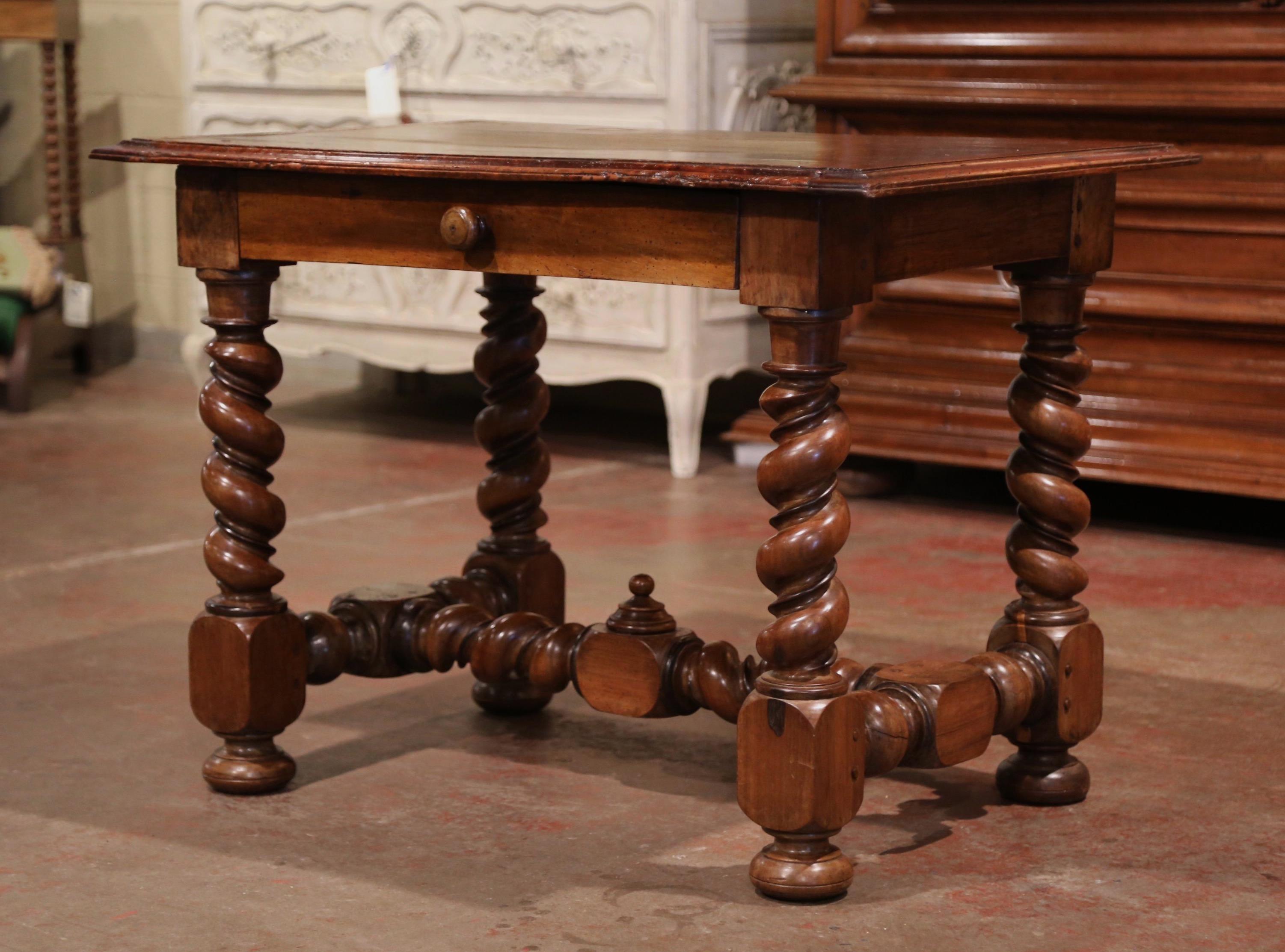 Incorporate extra, functional surface space into your living room or den with this elegant antique table. Crafted in the Perigord region of France, circa 1850, the side table stands on thick barley twist legs ending with bun feet, embellished with a