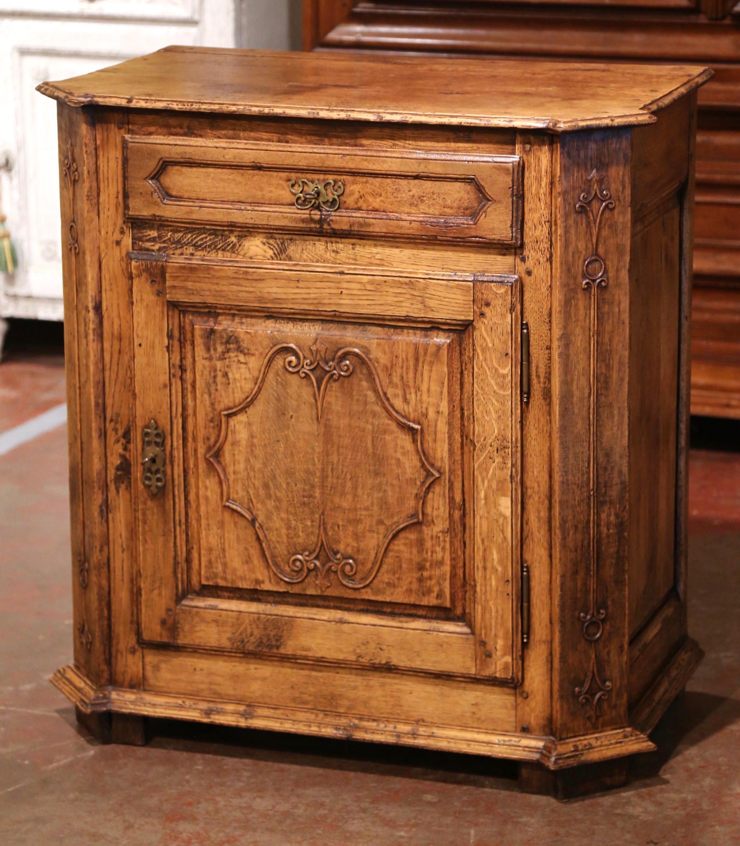 This elegant antique jelly cabinet was crafted in southern France, circa 1850. Standing on bracket feet over a molded plinth base, the provincial confiturier is fitted with a single drawer dressed with iron pull and lock, over a center door