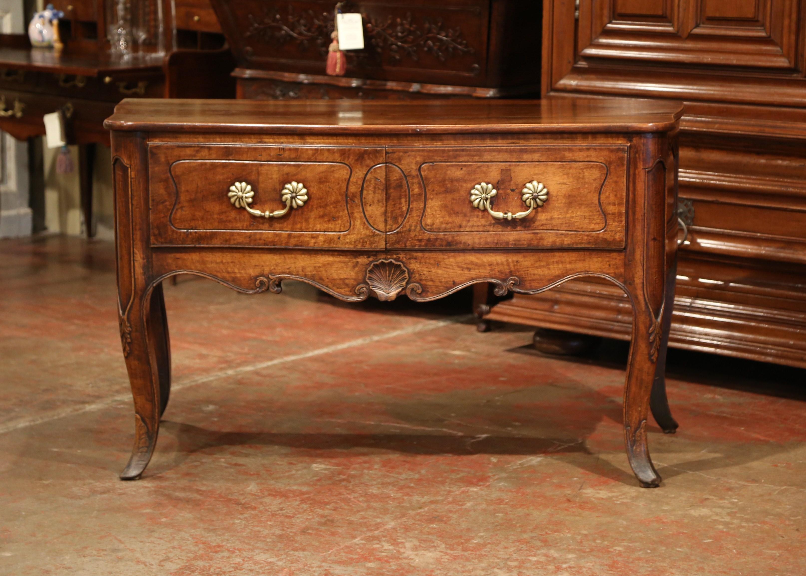 This elegant antique console table with bow front and curved sides was crafted in France, circa 1840. The fruit wood chest stands on four cabriole legs with sabot feet, and decorated at the knees with stylized foliate decor. Ornamented with a Louis