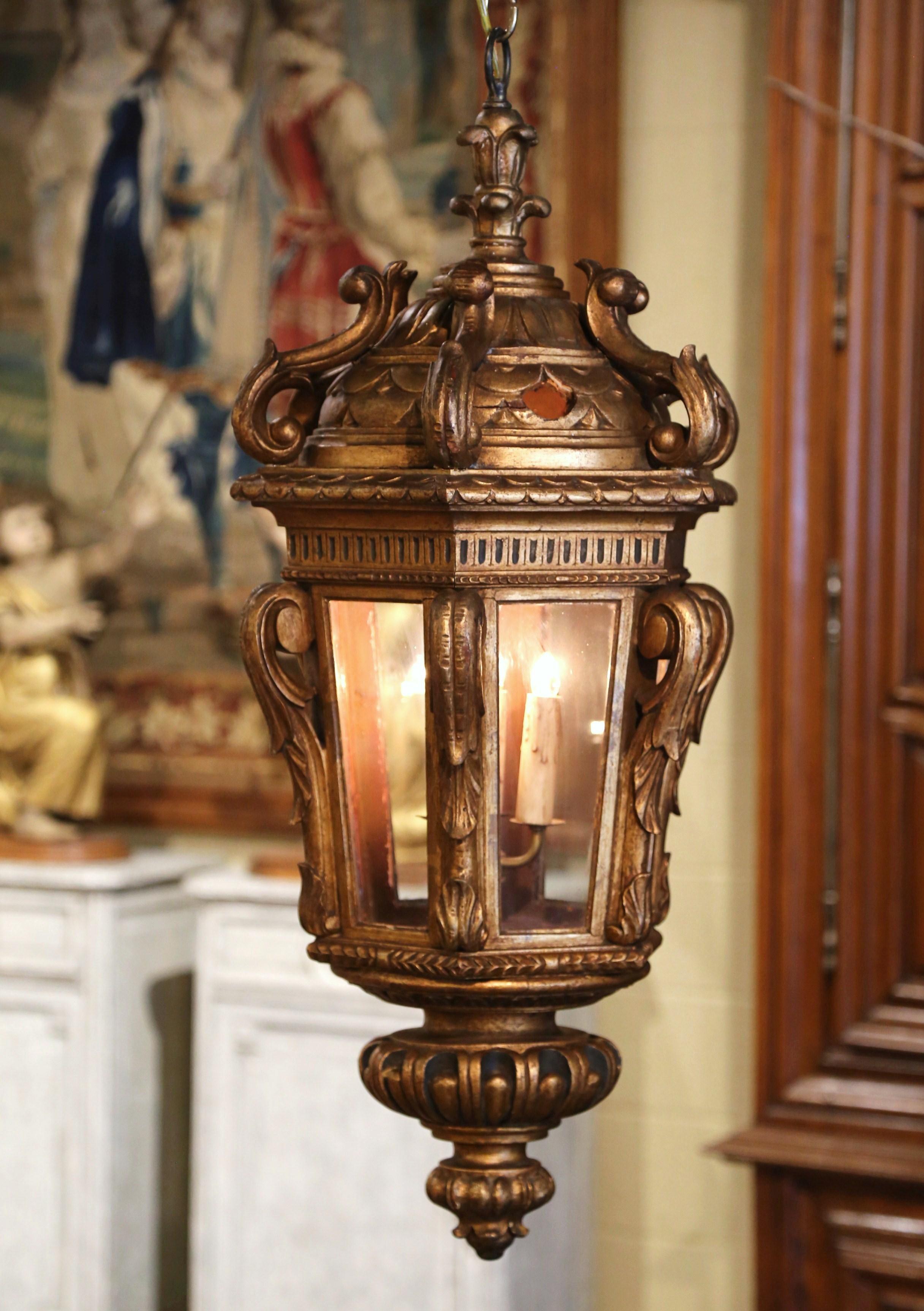 Bring Classic, French elegance into your home with this large rococo hand carved hall lantern. Crafted in France, circa 1860, this traditional hexagonal light fixture is a true showstopper. The wooden lantern with dome top and scroll decor, has