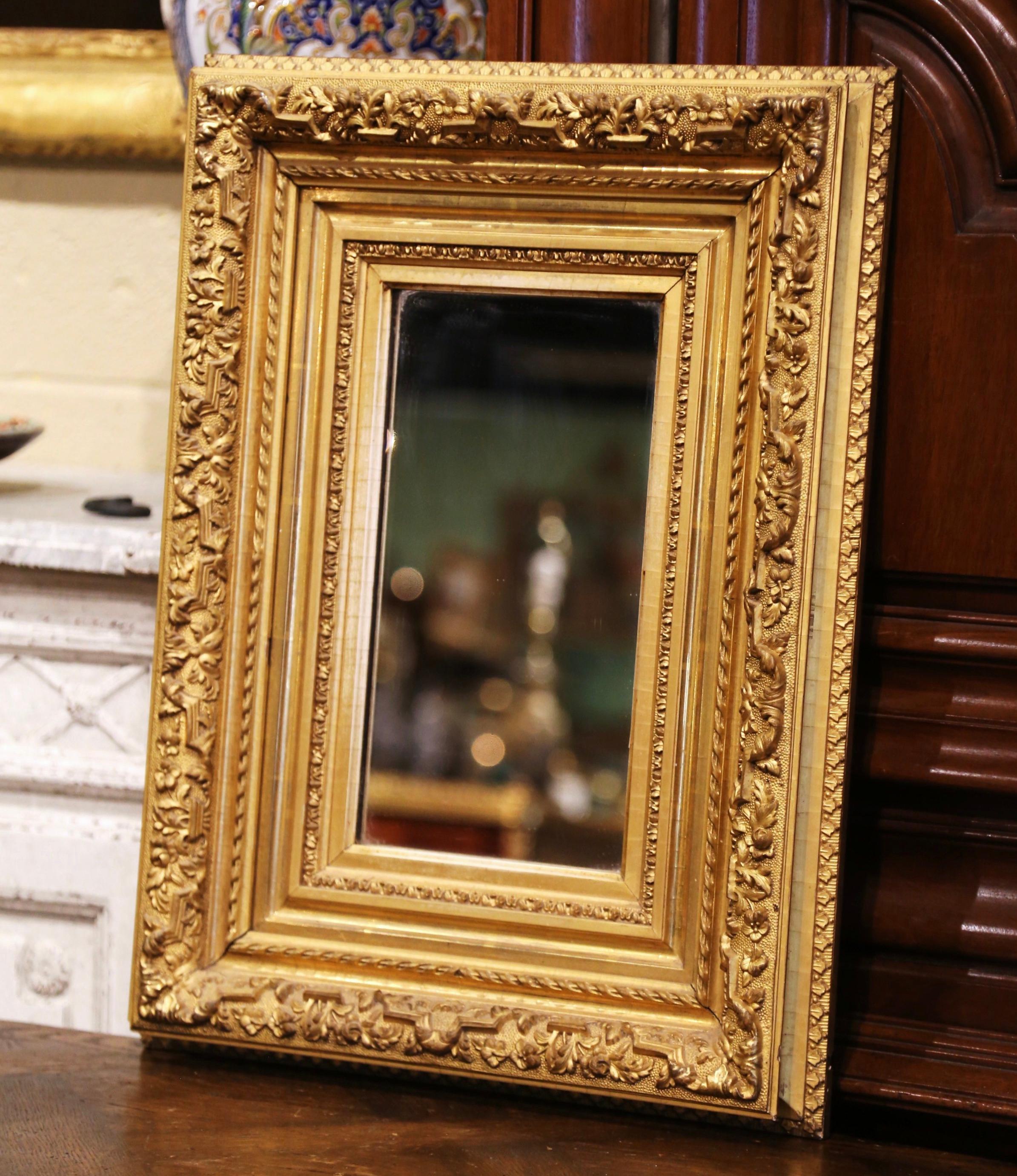 Decorate a hallway or small entry with this elegant antique gold leaf mirror. Crafted in the Burgundy region of France, circa 1860, the rectangular mirror has traditional lines with floral motifs in high relief; the frame is decorated with a