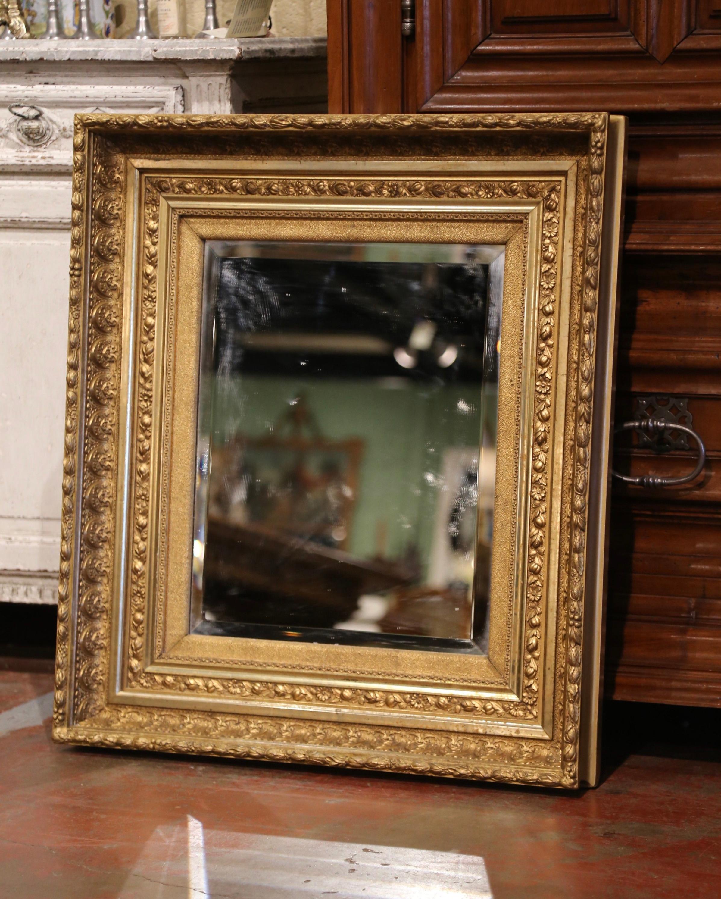 Decorate a powder room, entryway or bedroom with this elegant antique gold leaf mirror. Crafted in the Burgundy region of France, circa 1860, the rectangular mirror has traditional lines decorated with grape, floral, acorn and leaf motifs in high