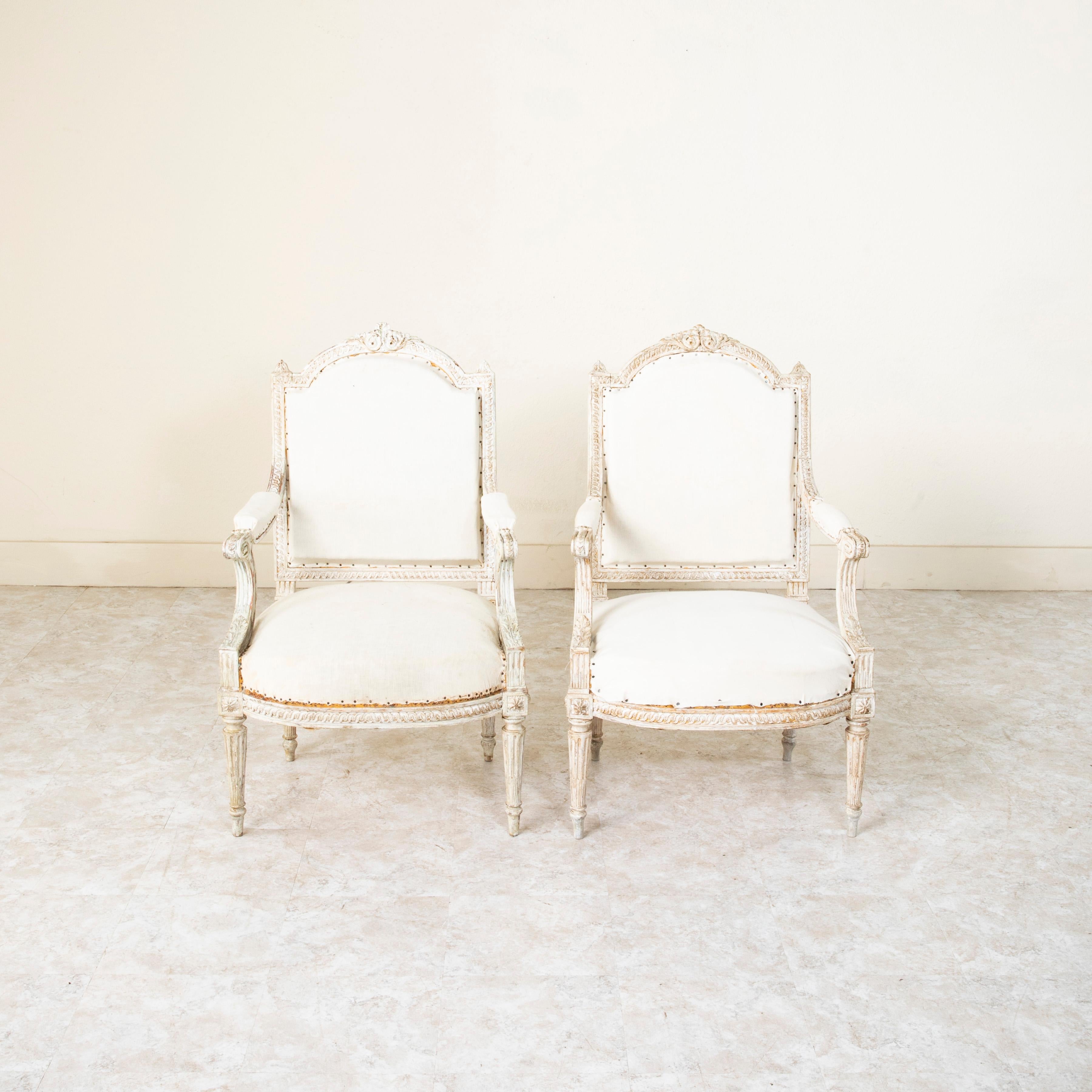 This pair of mid nineteenth Century Louis XVI style painted armchairs, features a seat back 