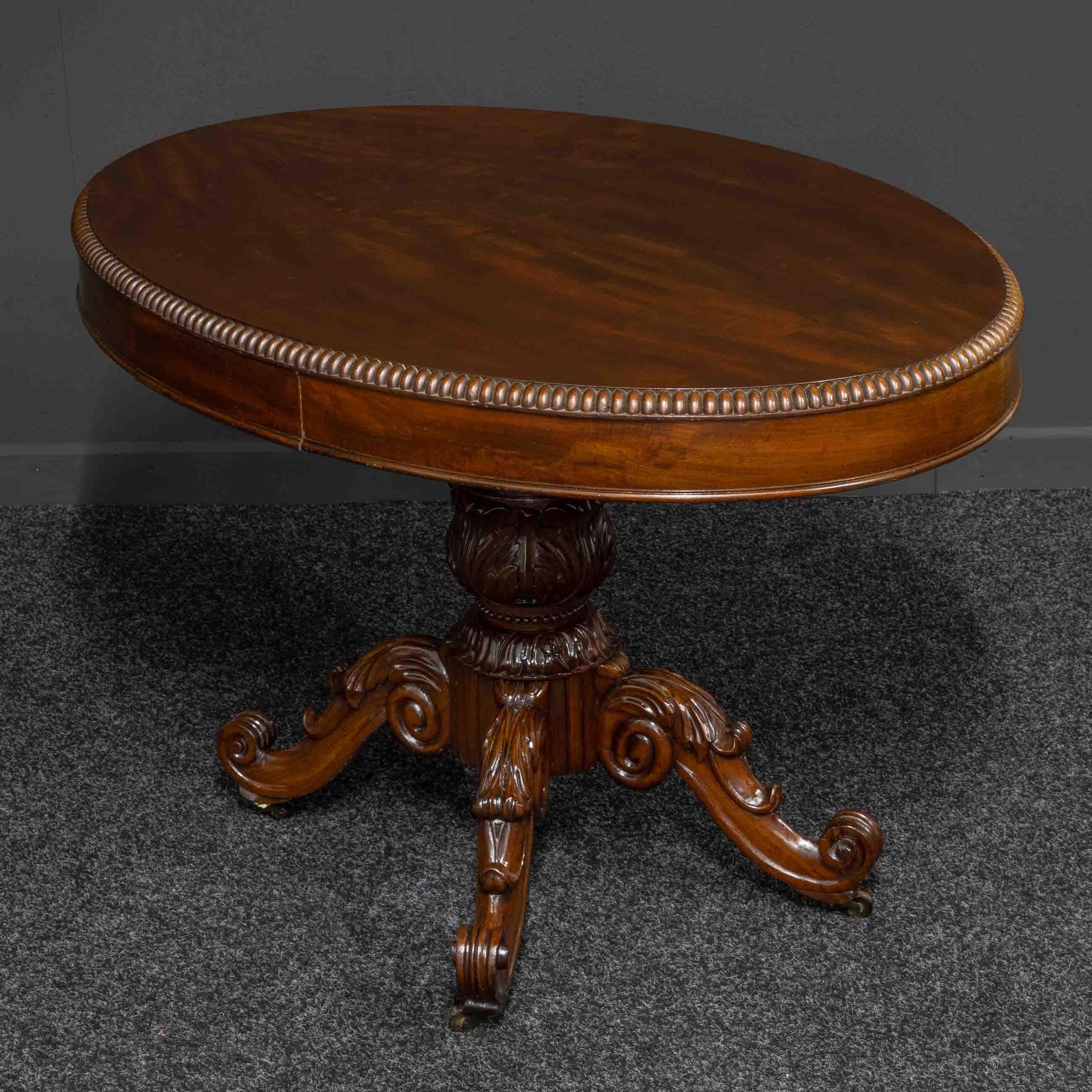 A superb quality French mahogany table from the mid-19th century. The base has four carved cabriole legs that still retain their original castors Whilst the oval top has a lovely split molded edging and two blind drawers. This table could be used