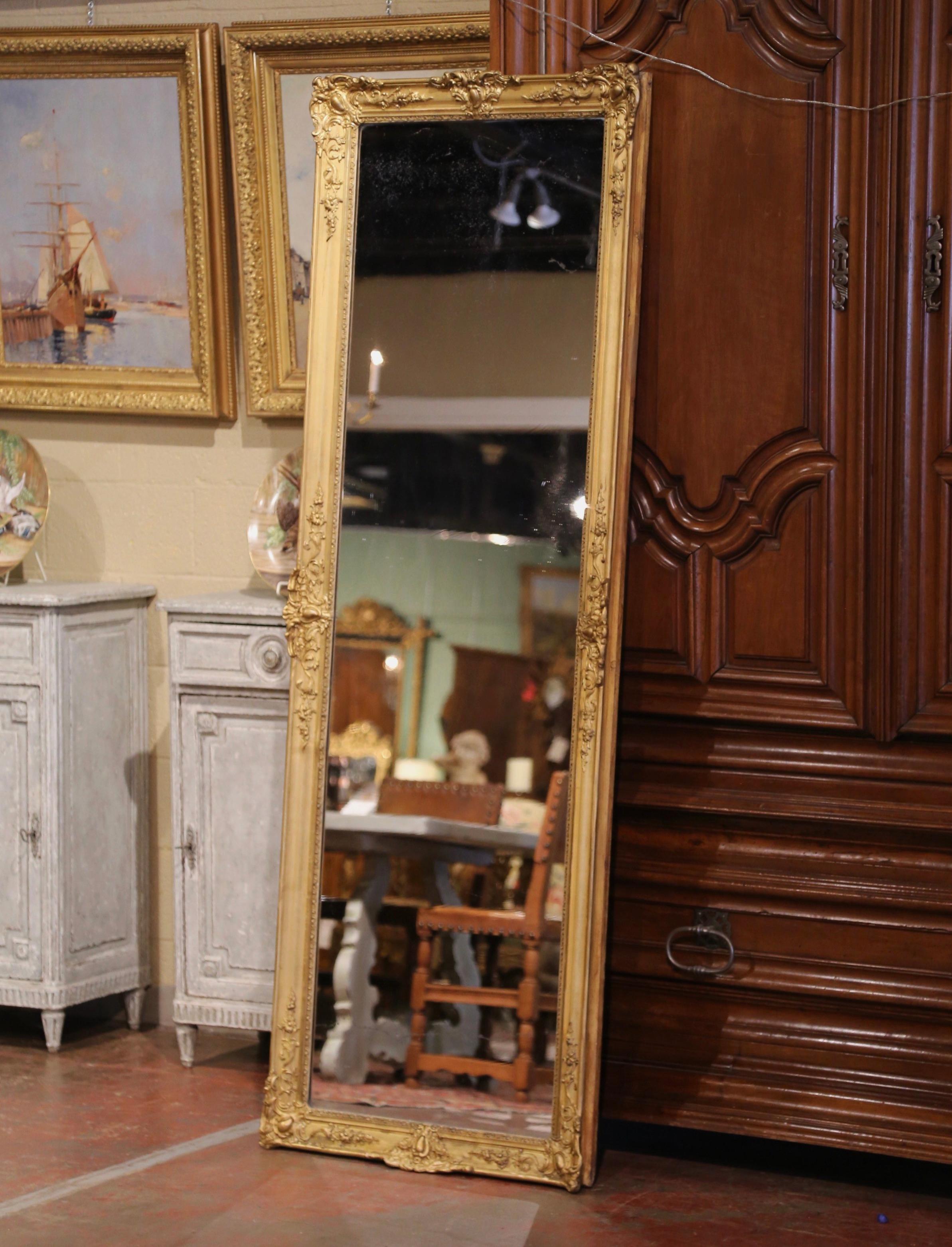 Decorate a master closet, dressing room or hallway with this tall and narrow antique gold leaf floor mirror. Crafted in the Burgundy region of France circa 1870, and over 6.5 feet in height, the large mirror has traditional lines with shell and
