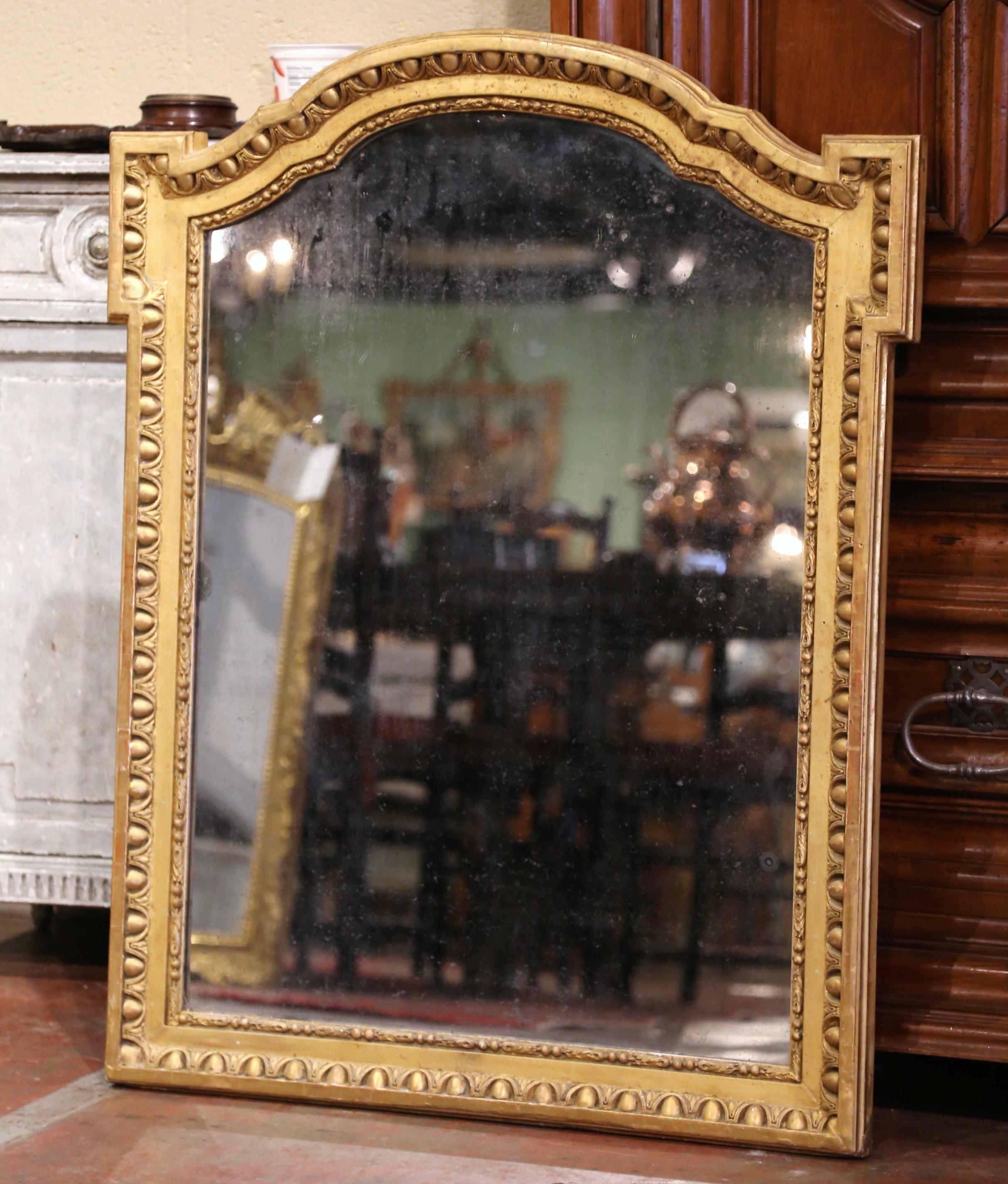 Decorate an entry or a bedroom with this elegant antique mirror. Crafted in the Burgundy region of France, circa 1860, the rectangular mirror has traditional, timeless lines with an elegant arched top. The carved frame is decorated with a luxurious
