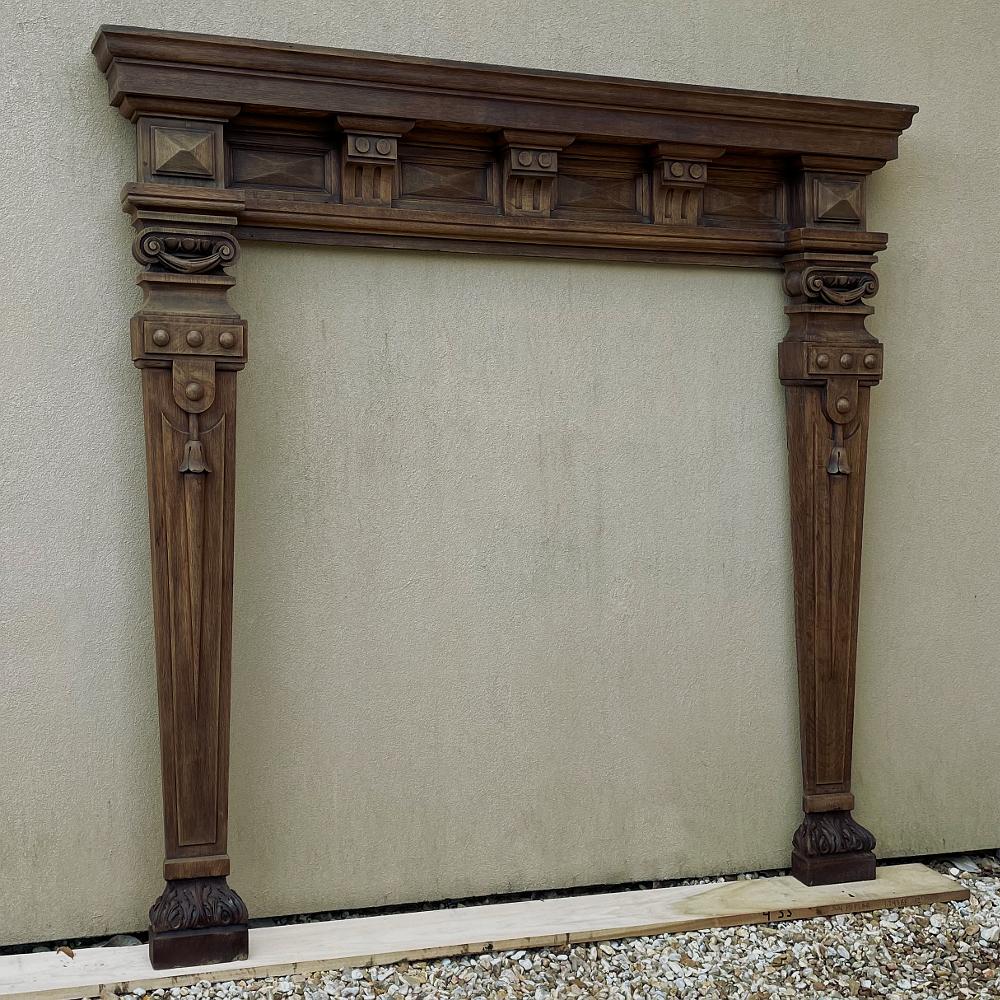 Mid-19th Century French neoclassical carved fireplace surround is the perfect choice to create a stunning visual focal point in your favorite room! Standing a majestic seven feet tall, it was designed for a grand scale, and features Neoclassical