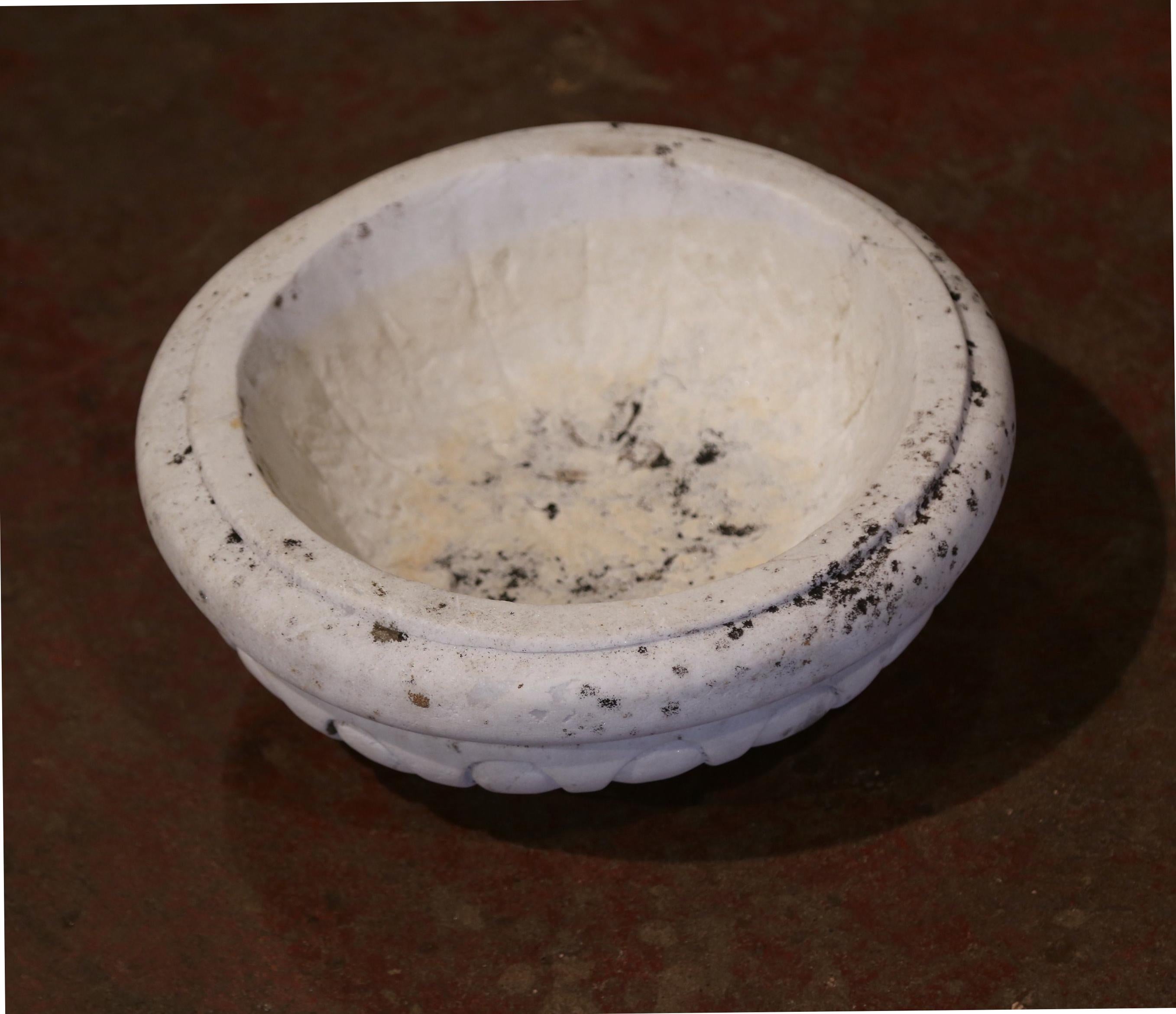 This antique bowl was carved in Southern France, circa 1850; round in shape, the piece had neoclassical lines and features a wonderful weathered patinated finish. The planter is in excellent condition, and could also be used as a vide-poche to catch