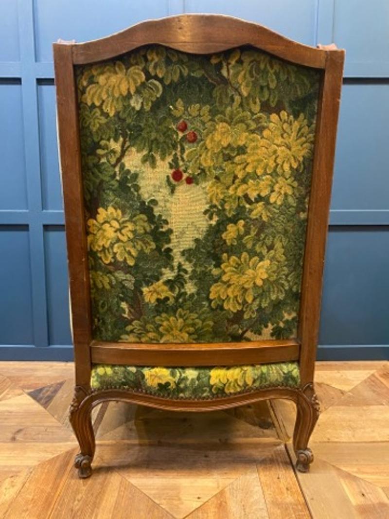 Mid-19th Century French Oak Armchair with Velvet and Tapestry Upholstery
Velvet upholstery with beautiful needlework tapestry on the back of the chair. French oak wood frame with nail heads and rosette carvings on front legs. Beautifully unique and