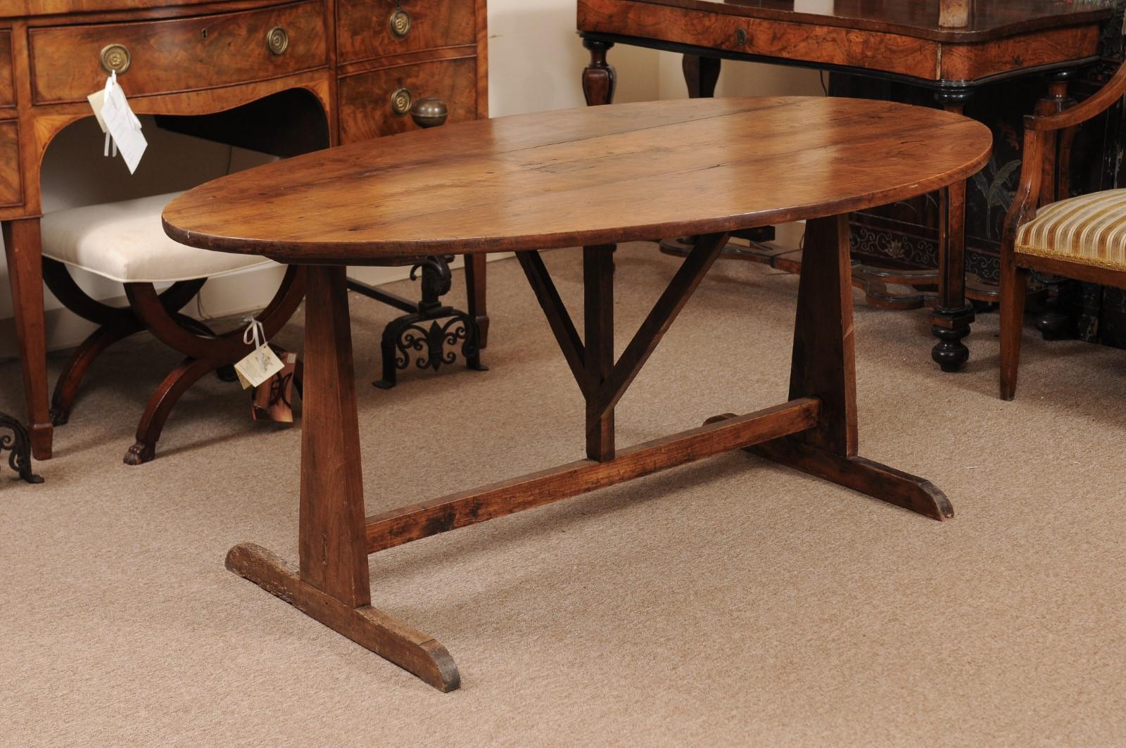 The mid-19th century French wine tasting table in fruitwood with oval top and tilting mechanism.

 