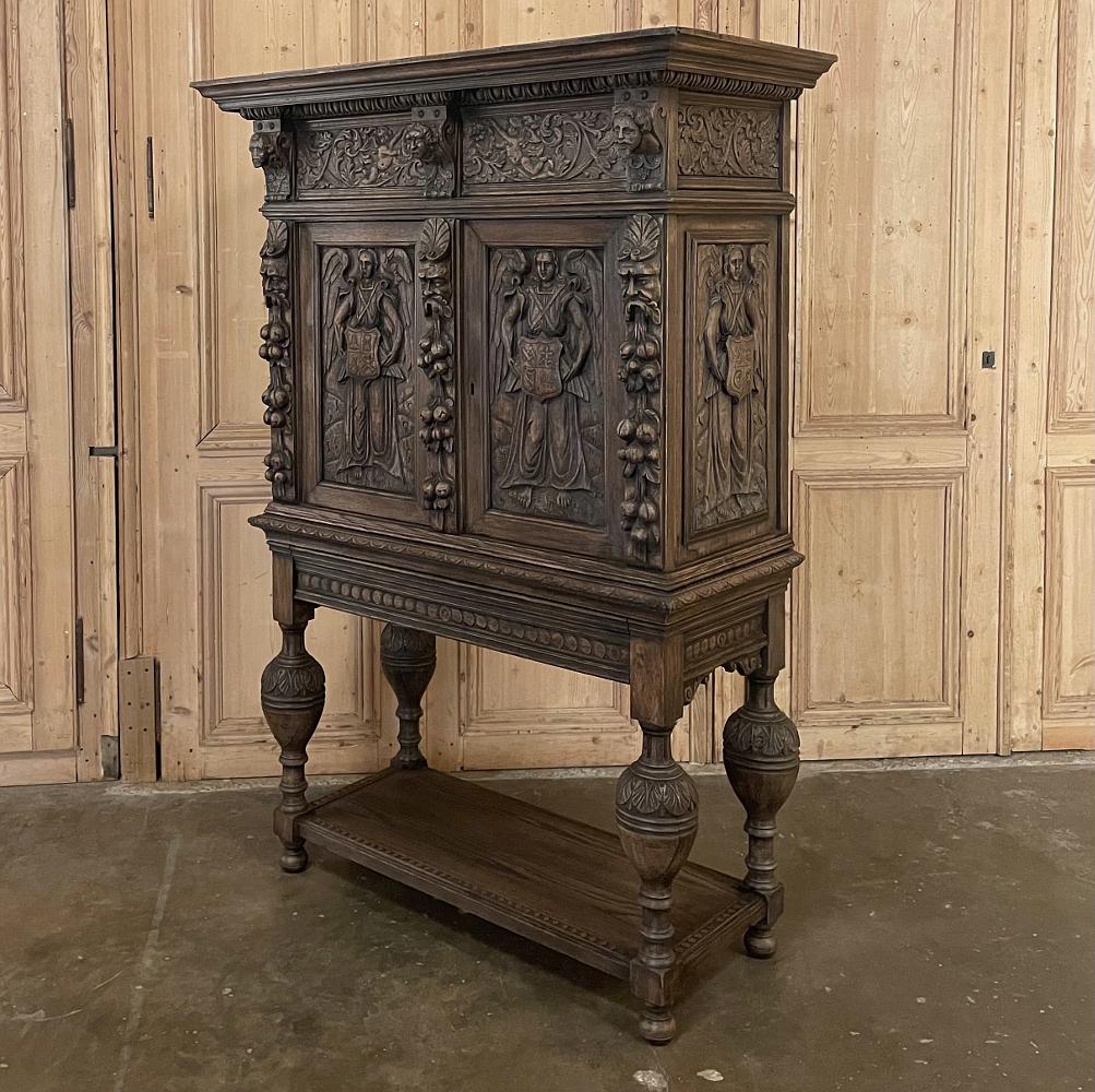 Mid-19th century French Renaissance raised cabinet is a stunning example of the sculptor's art, with amazing detail in abundance from the boldly molded crown to the four finely carved urn pediments that serve as the legs for the piece, connected