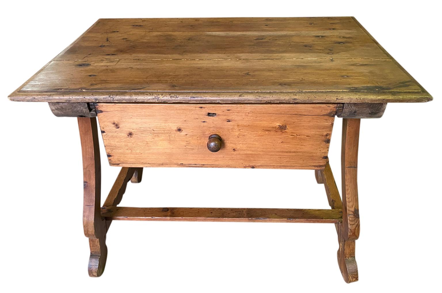 A very charming and rustic mid-19th century side table from the Southwest of France. Soundly constructed from beautifully patina'd pine with a single deep drawer and classical lyre styled legs. A wonderful accent table.