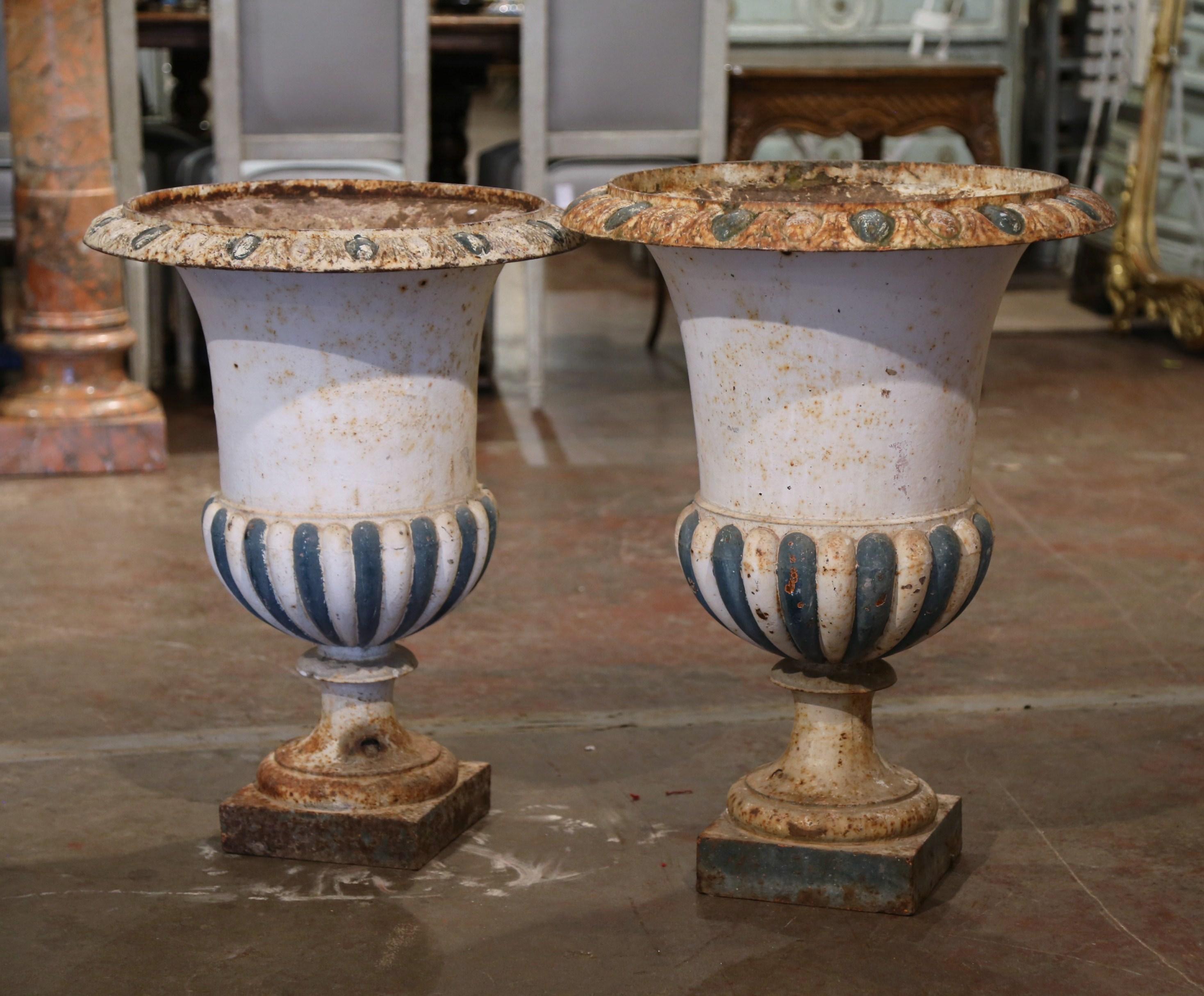 Place these large vases at your front or back door! Crafted in France circa 1850, the antique Campana form urns stand on a square base with a wide mouth at the top, and feature the original painted and weathered finish. The tall Medici planters are