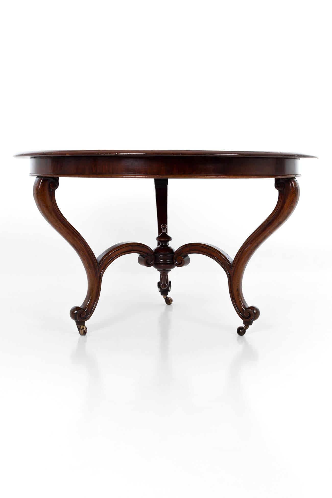 Fabulous mid-19th century fruitwood centre table in exceptional condition. The round top, with a rich chestnut colour, sits on three scrolling cabriole legs joined together by conforming stretchers. Elegant proportions, striking central upturned