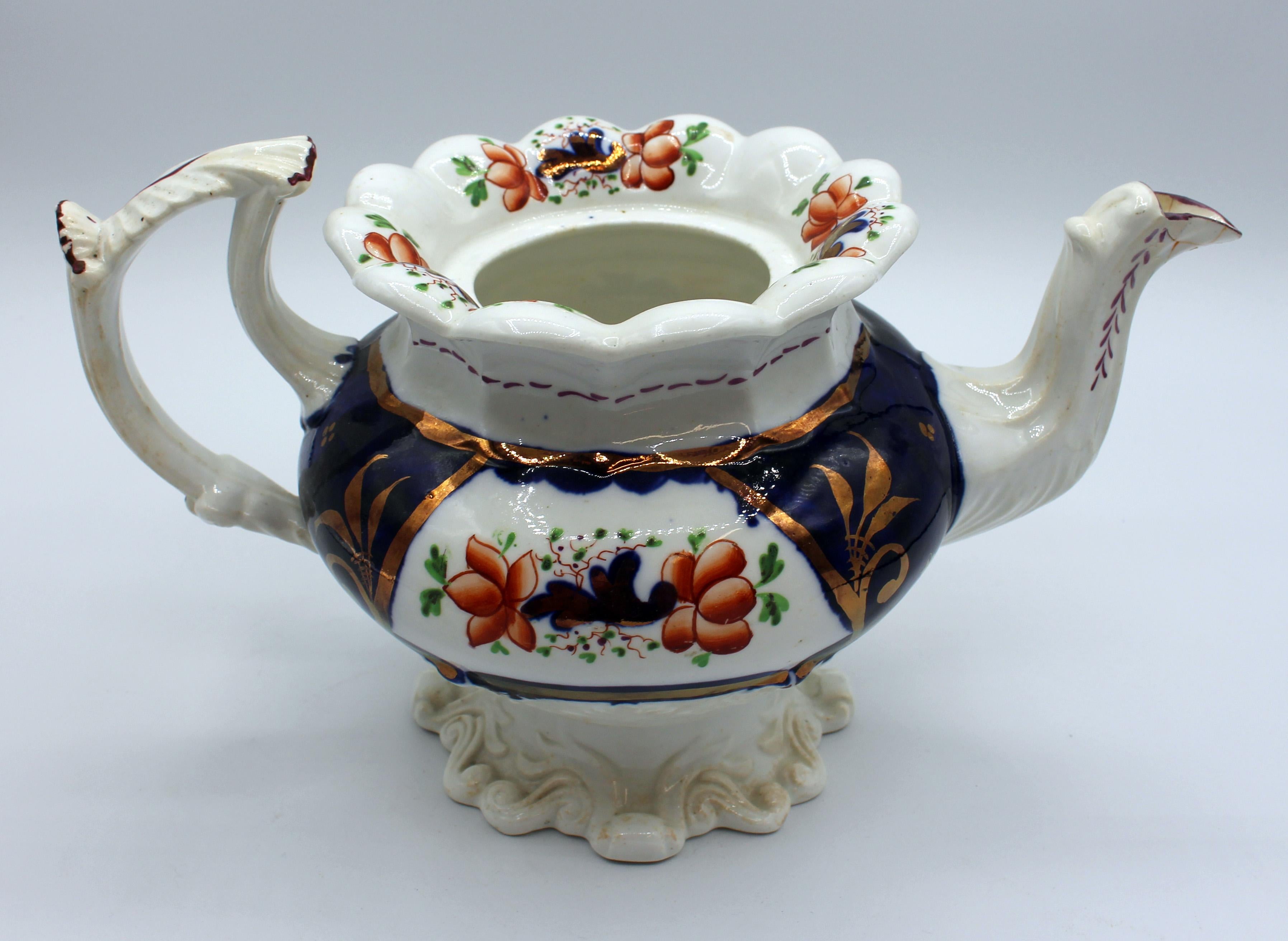 Mid-19th Century Gaudy Welsh tea set - pot, cream & covered sugar. English porcelain, Staffordshire district. Molded bodies with lush scrolling leaves. Old spout repair; light staining; tiny base nibble on creamer. Measures: Pot: 11