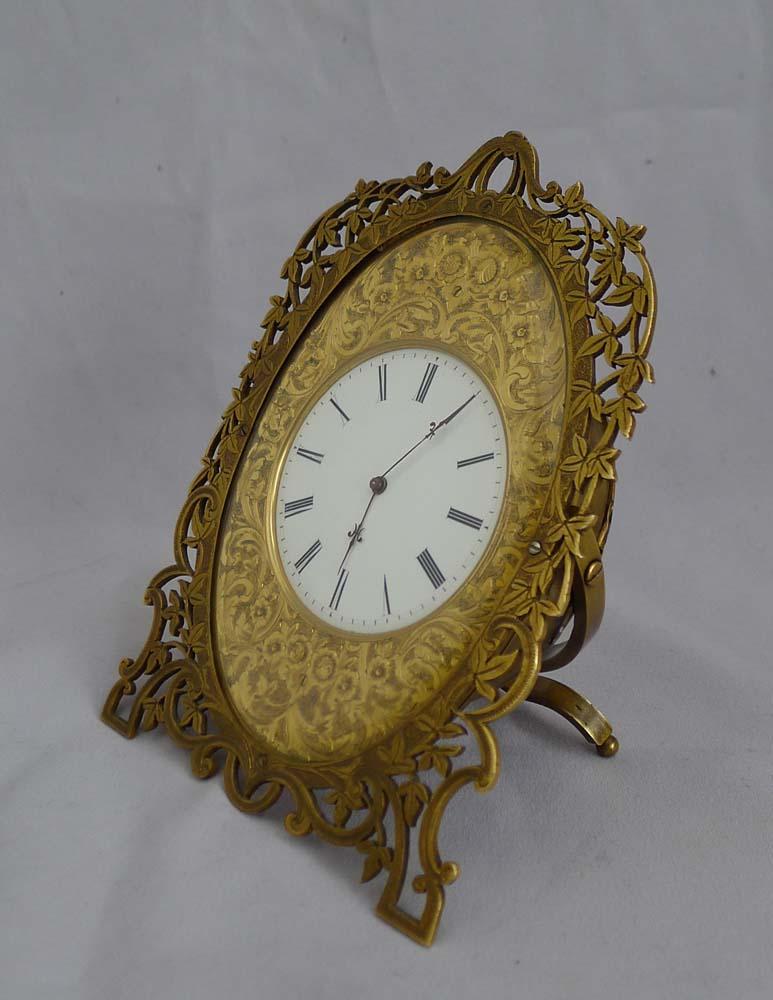 Mid-19th century gilt bronze strut clock in the style of Cole. Original gilding and very fine engraving make this a most attractive clock. The pierced ormolu frame gives a very light feeling while there is a beautiful contrast between the