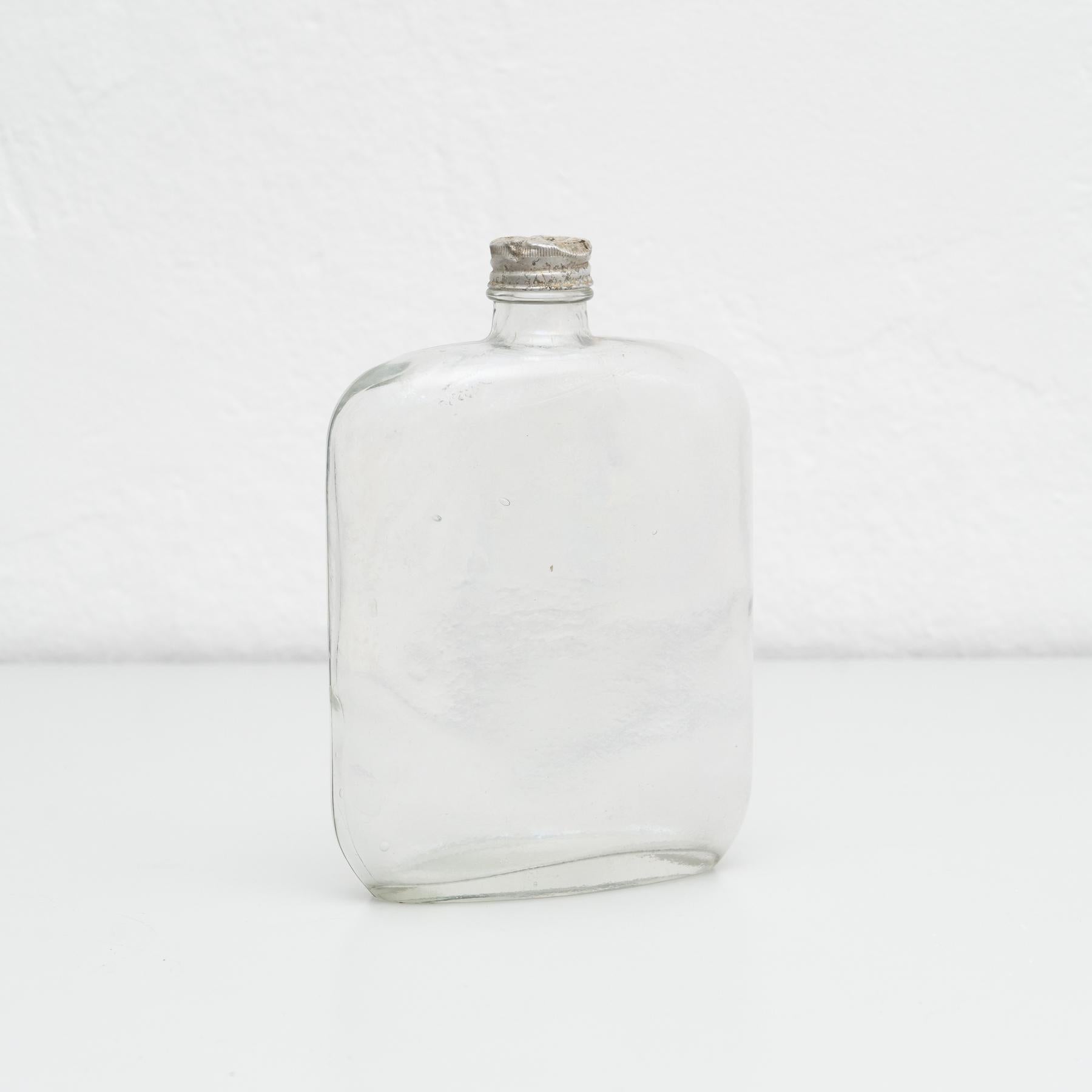 Mid-19th century glass bottle with metal cap.

By unknown manufacturer from France.

In original condition, with minor wear consistent with age and use, preserving a beautiful patina.

Materials:
Glass

Dimensions:
ø 9.5 cm x H 22.5 cm.