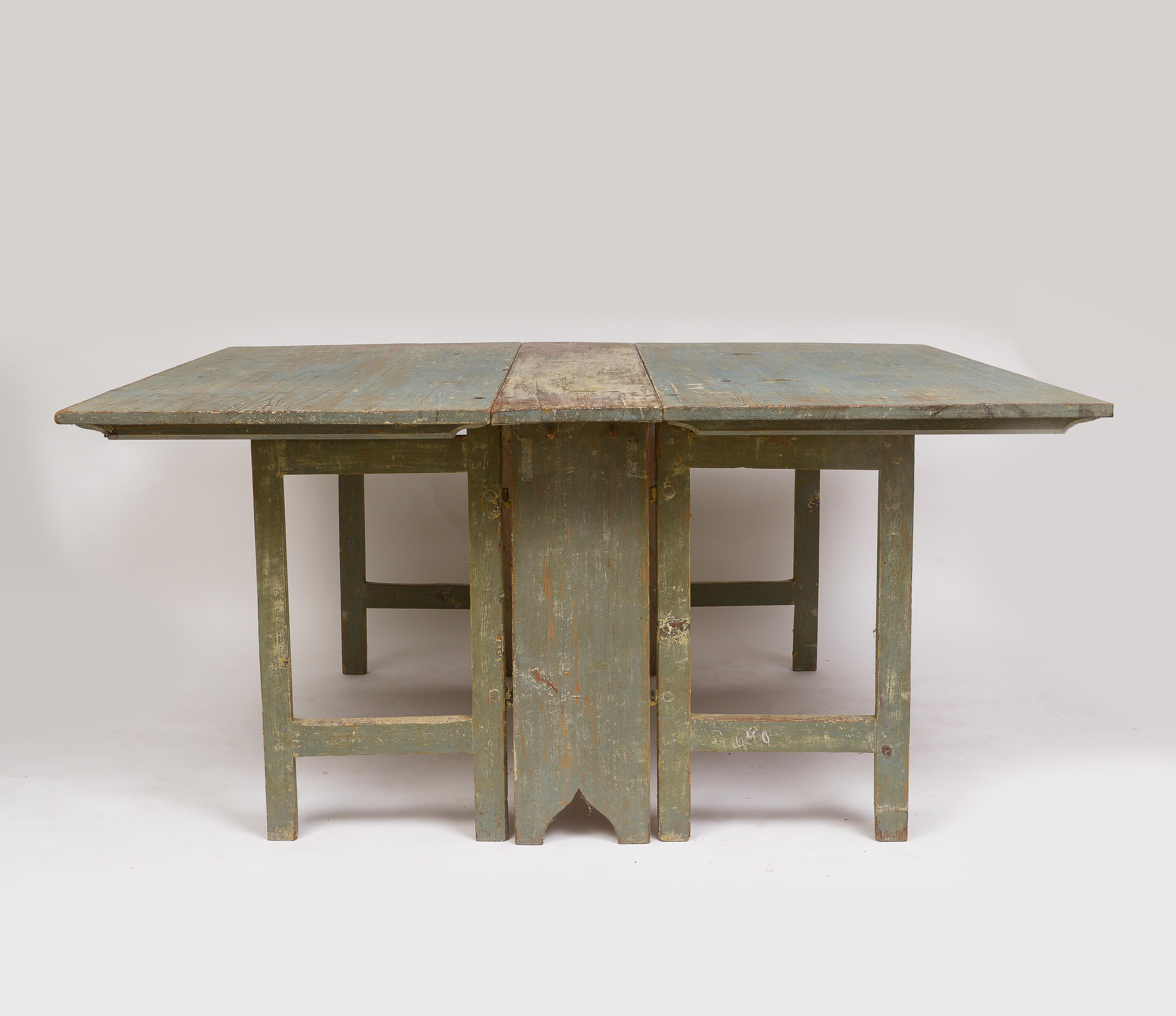 Faded gray painted drop leaf table
Beautiful patina the height of Swedish style
Gate legs fold to a narrow side table