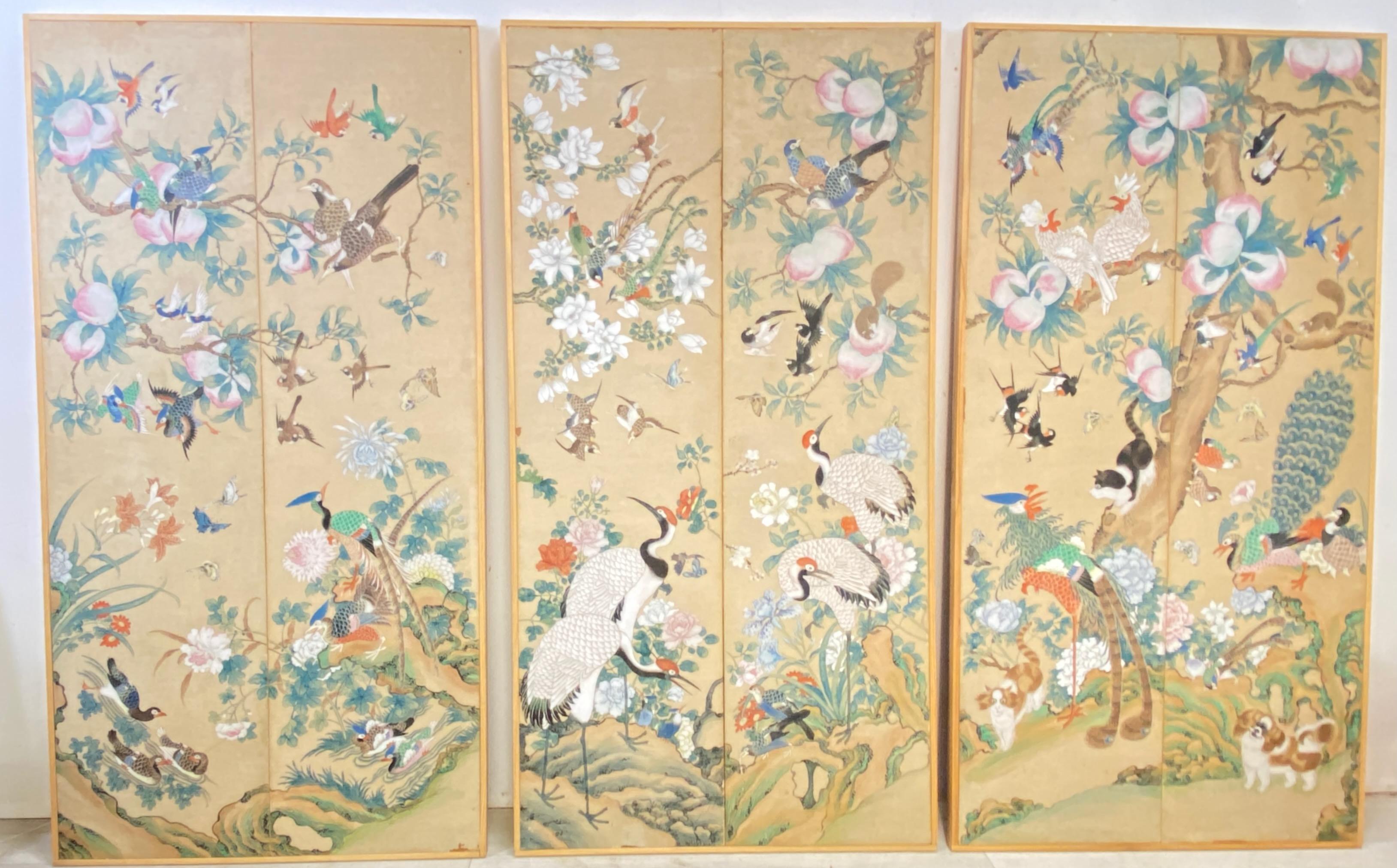 A set of three mounted hand painted wallpaper panels in simple wood frames.
Beautifully and elaborate painted scenes with birds, flowers, butterflies, cats, dogs, squirrels, fruit and foliage. 
Most likely this was originally part of a much larger