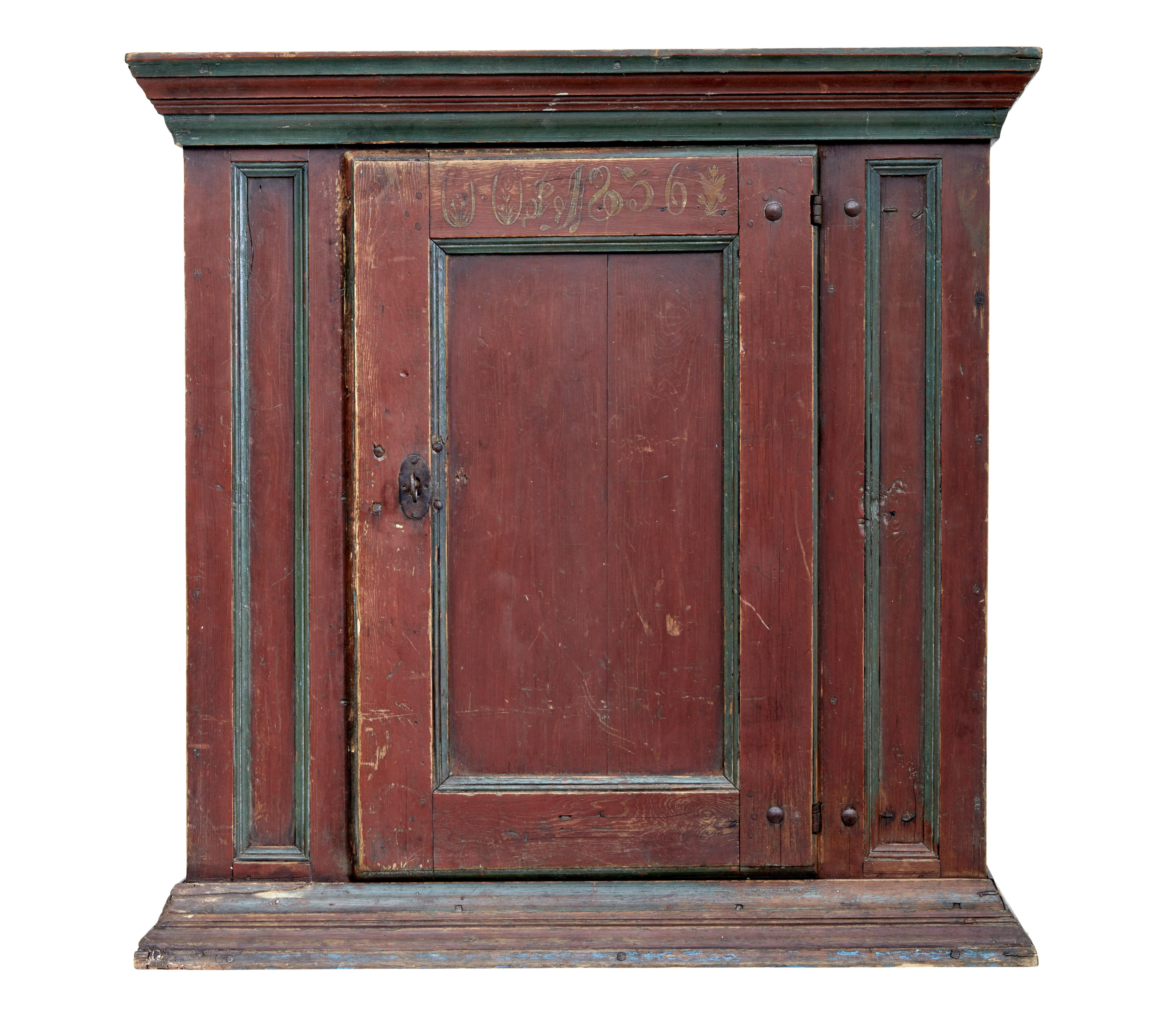 Mid-19th Century hand painted folk art cupboard, circa 1856.

Swedish floor standing cupboard with a hand painted date of 1856, but we believe the piece to be earlier. Quite possibly a top section from a larger cabinet, or hung from a wall.