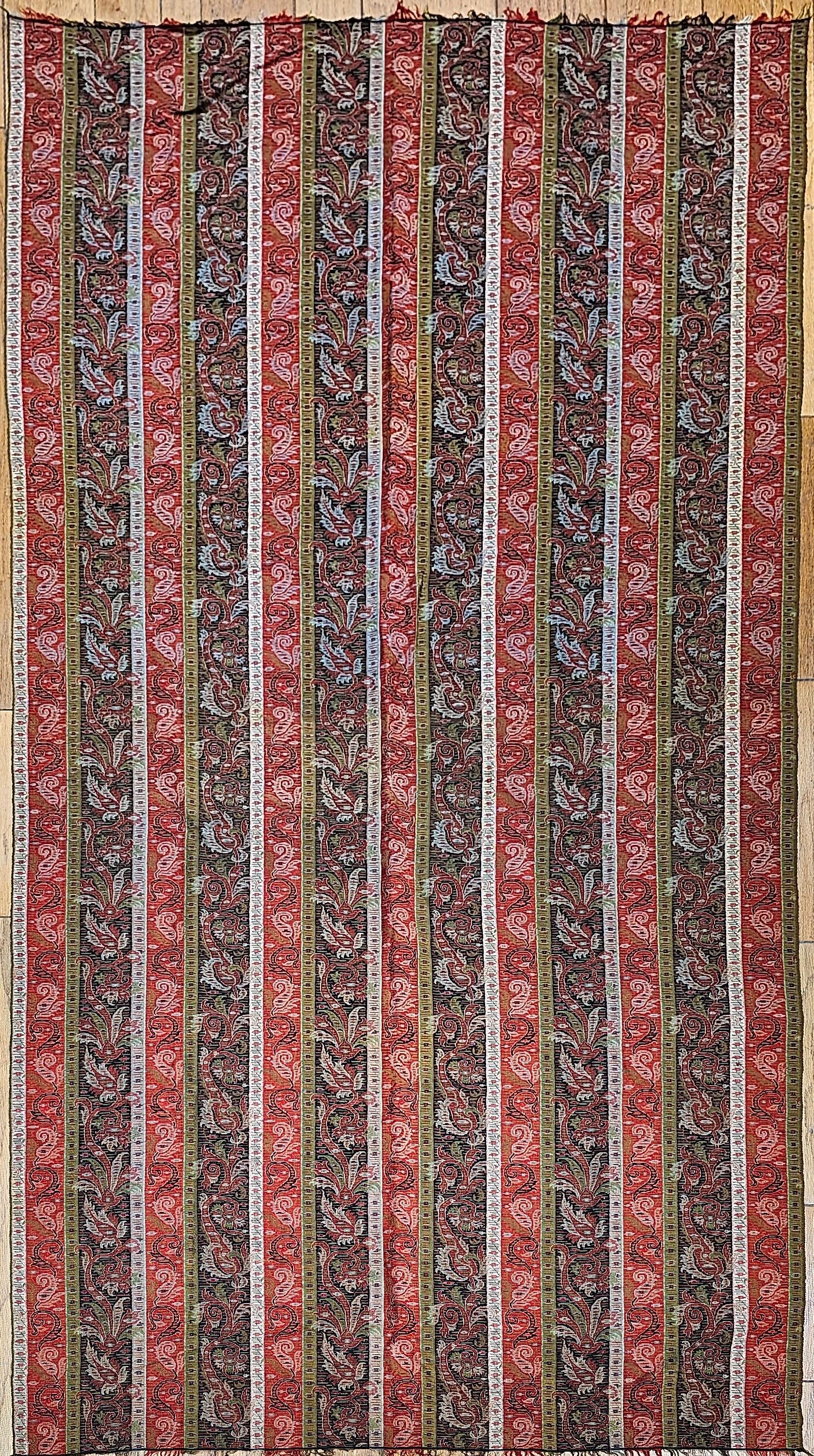 19th Century hand -woven Kashmiri Paisley Shawl from NW India in brick red, ivory, black and green.  The shawl has a paisley pattern as the border with larger paisley form on each end with a center part of the shawl woven in a blank black material. 
