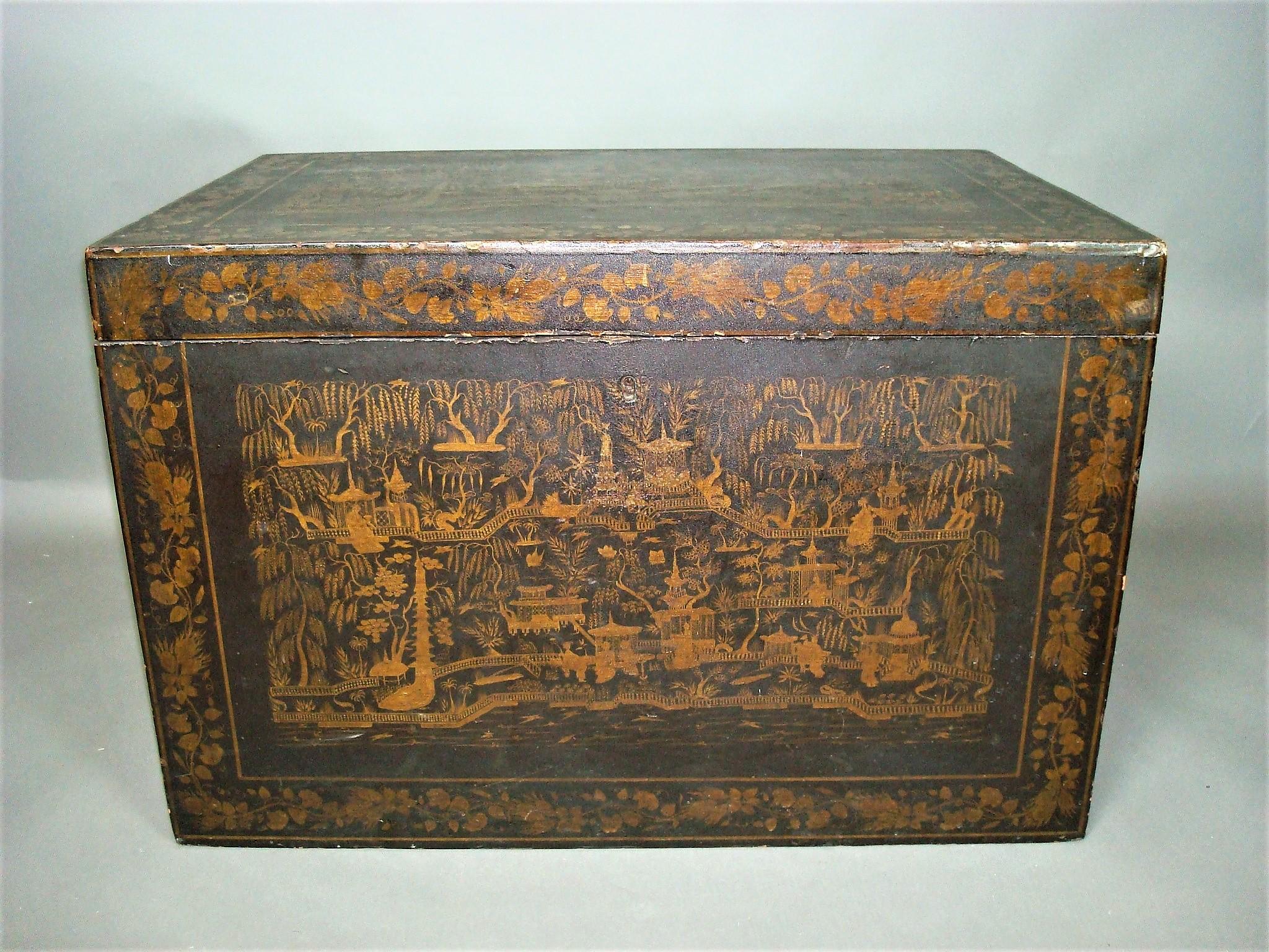 A good mid-19th century Indian chinoiserie lacquered trunk; the rectangular hinged lid revealing the original vivid blue painted interior, retaining its original lift out tray with pierced carrying handles. The whole trunk profusely decorated in