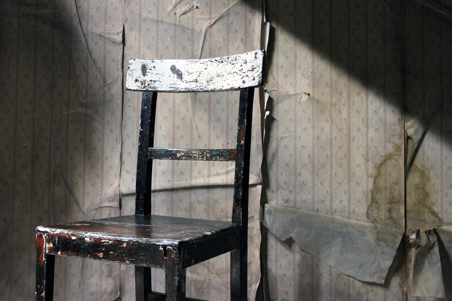 The original painted pine side chair showing many superb worn pigment and layers of paint, having a bar back worn through to white, the two plank seat worn further showing green, white, rust and ochre, the whole on block legs joined by stretchers,,