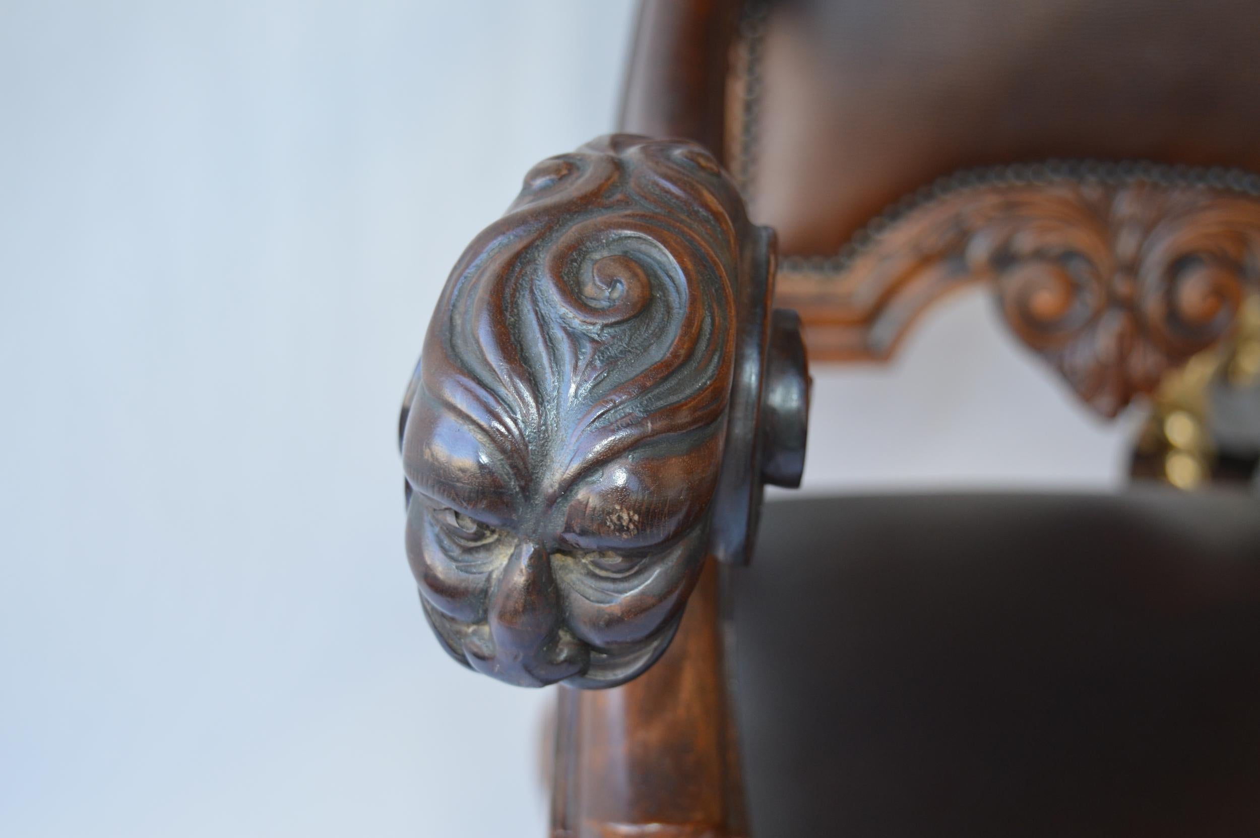 Mid-19th century Italian Baroque style armchair in hand carved walnut and leather upholstery.