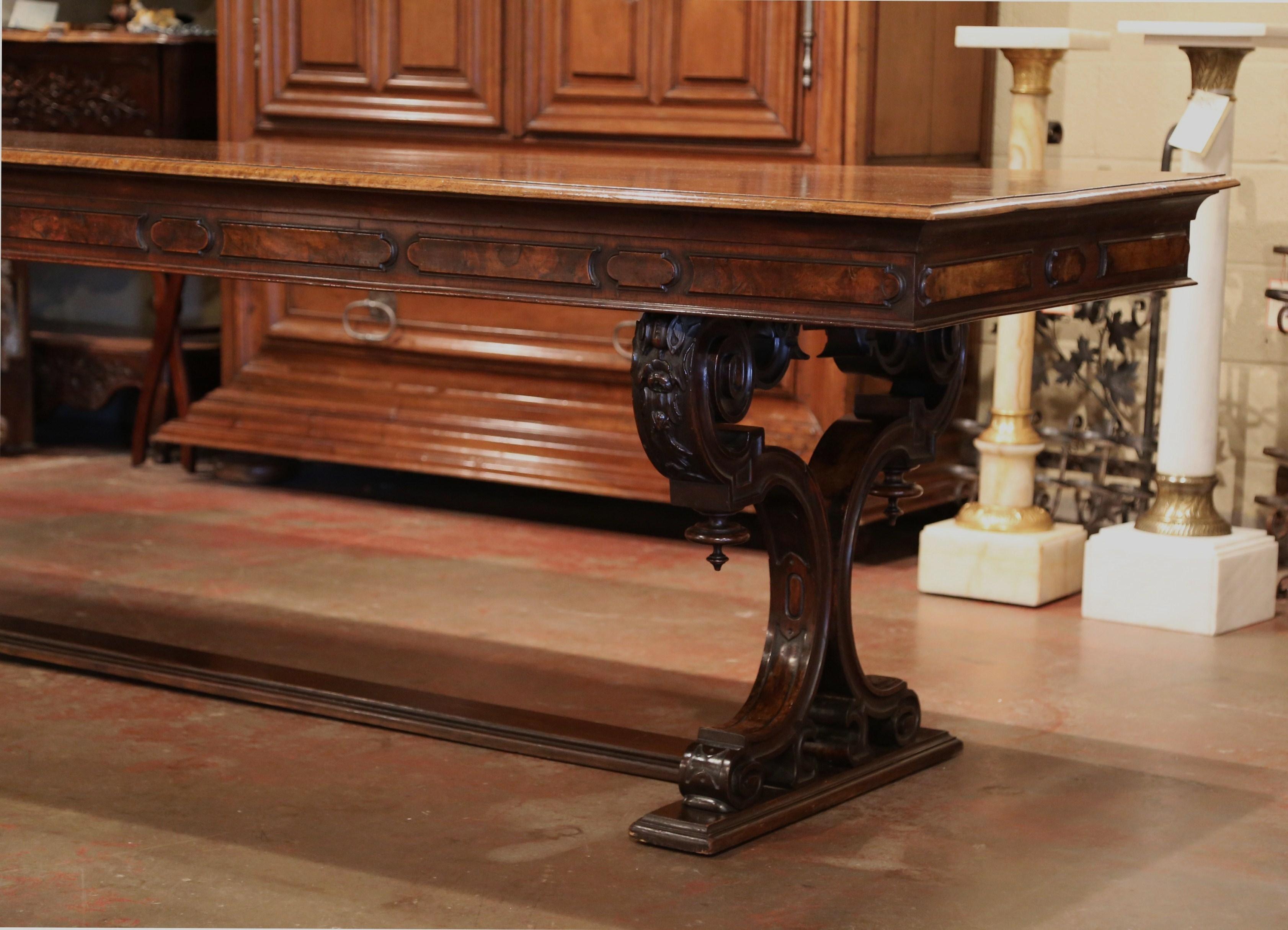Bring the Italian elegance in your dining room with this important, antique farm table. Crafted in Italy circa 1850, the impressive, fruitwood table stands on two carved pedestal legs that are embellished with a lyre, decorative finial and foliage