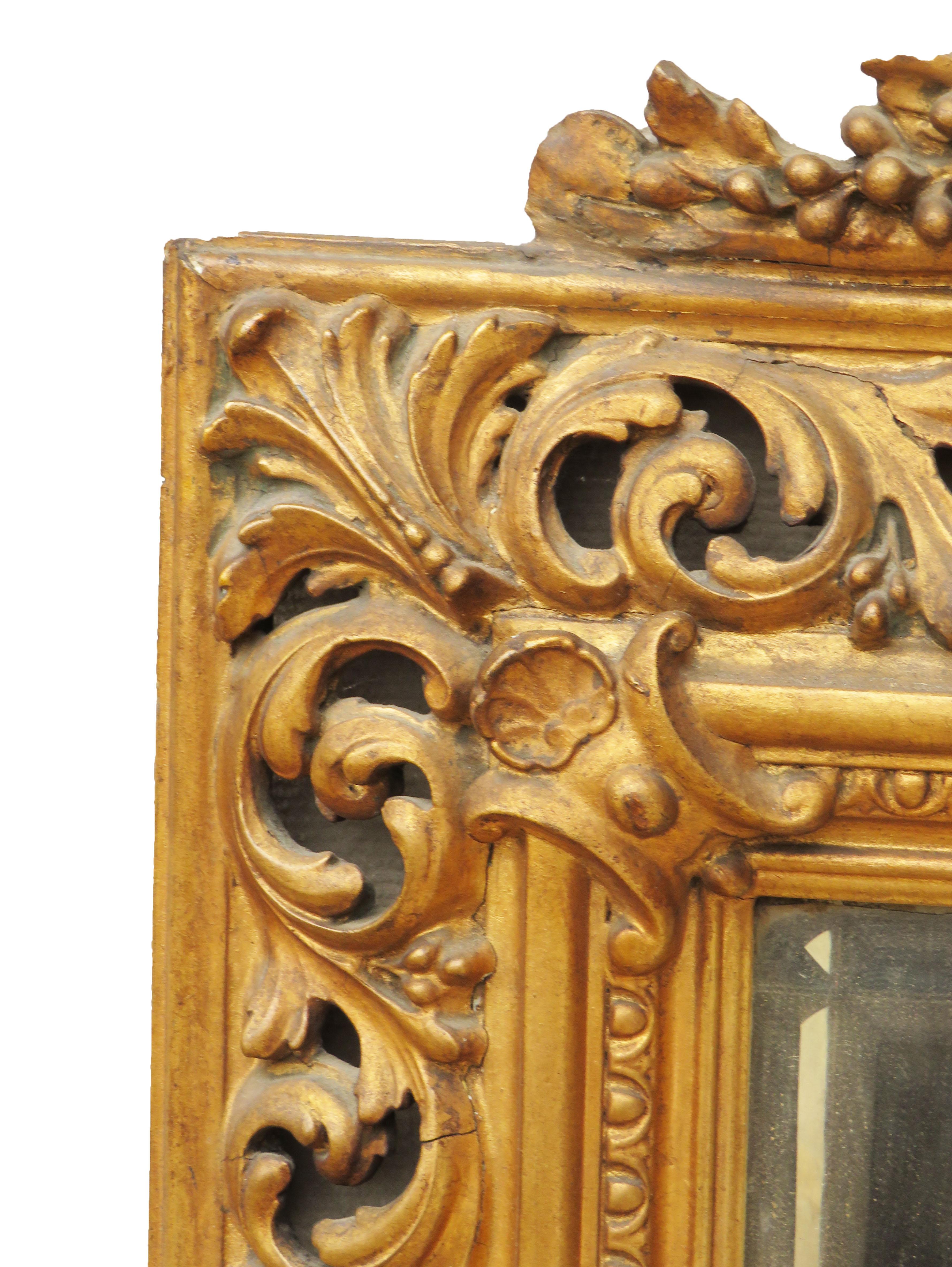 A very attractive mid-19th century giltwood and gesso
wall mirror having carved surmount over pierced
Frame bordering replacement beveled mirror plate

(This mirror would of been made during the mid-19th century
in Italy. It is a typical