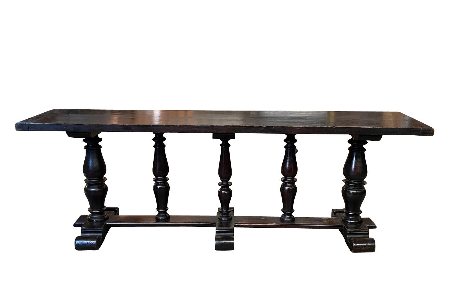 A very striking mid-19th century grand scale console table from northern Italy. Handsomely constructed from beautiful walnut in the Louis XIII style with a solid board top and wonderfully turned legs. Terrific patina.