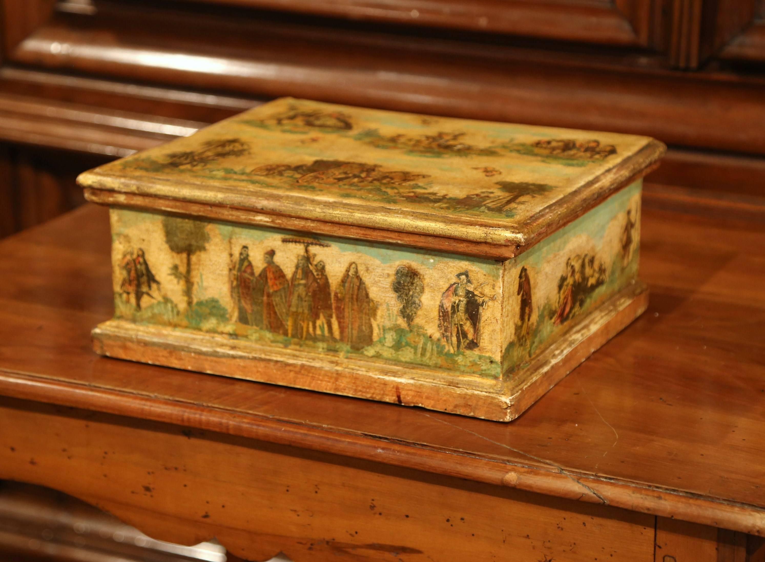 This elegant antique box was crafted in Italy, circa 1850. The colorful, detailed box features hand painted scenes of people with horses and butterflies. The rectangular box has its original painted finish in a yellow and green palette embellished