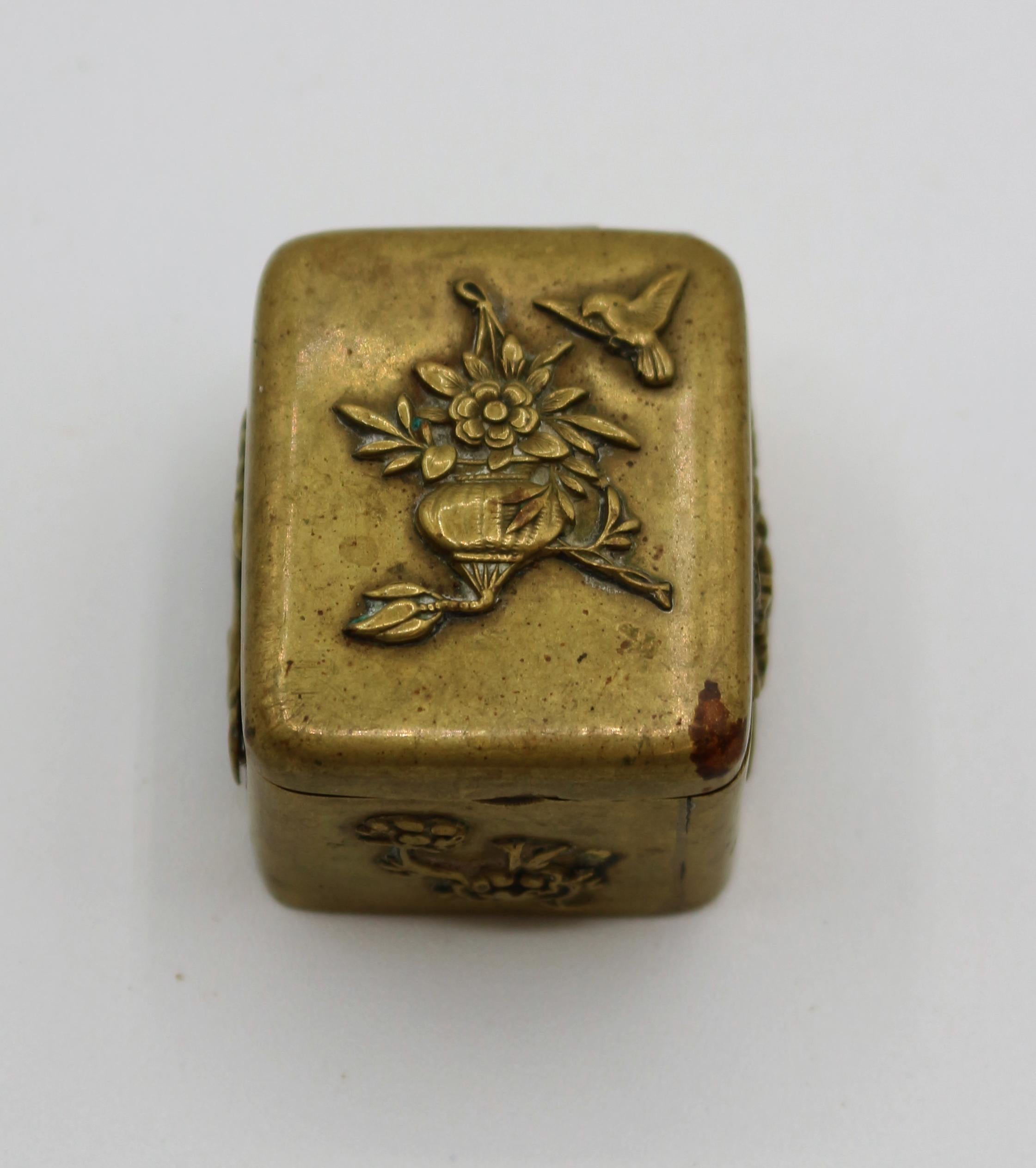 Mid-19th century Japanese Meiji period bronze stamp box. Applied castings of a hanging flower basket with bird, recumbent stag and flowers. Measures: 1 1/4